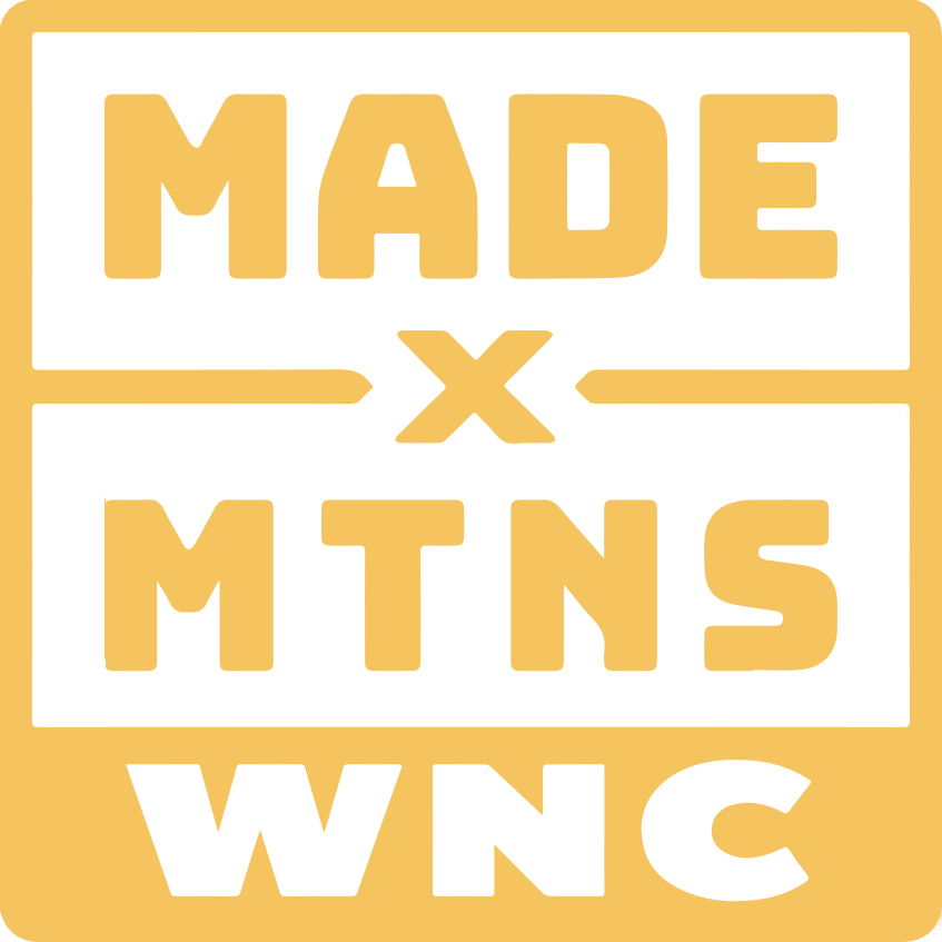 Logo with the words 'Made x Mtns' and 'WNC' in bold yellow and black text.