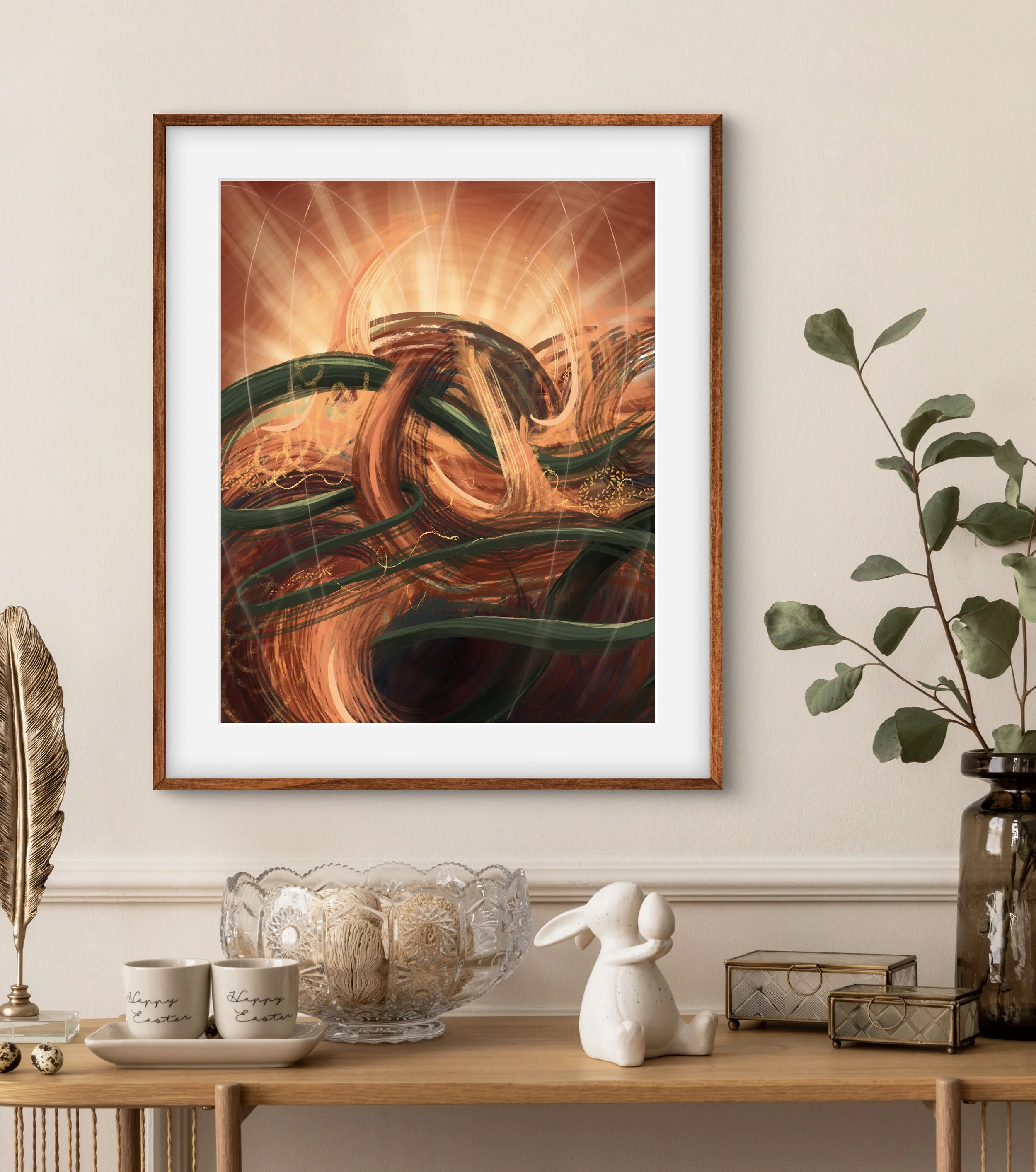 Decorative abstract artwork with warm orange and green swirling patterns on the wall above a wooden console table, which holds Easter-themed decor including cups, a glass bowl with decorative eggs, a ceramic bunny, and decorative boxes, with a leafy plant to the right.