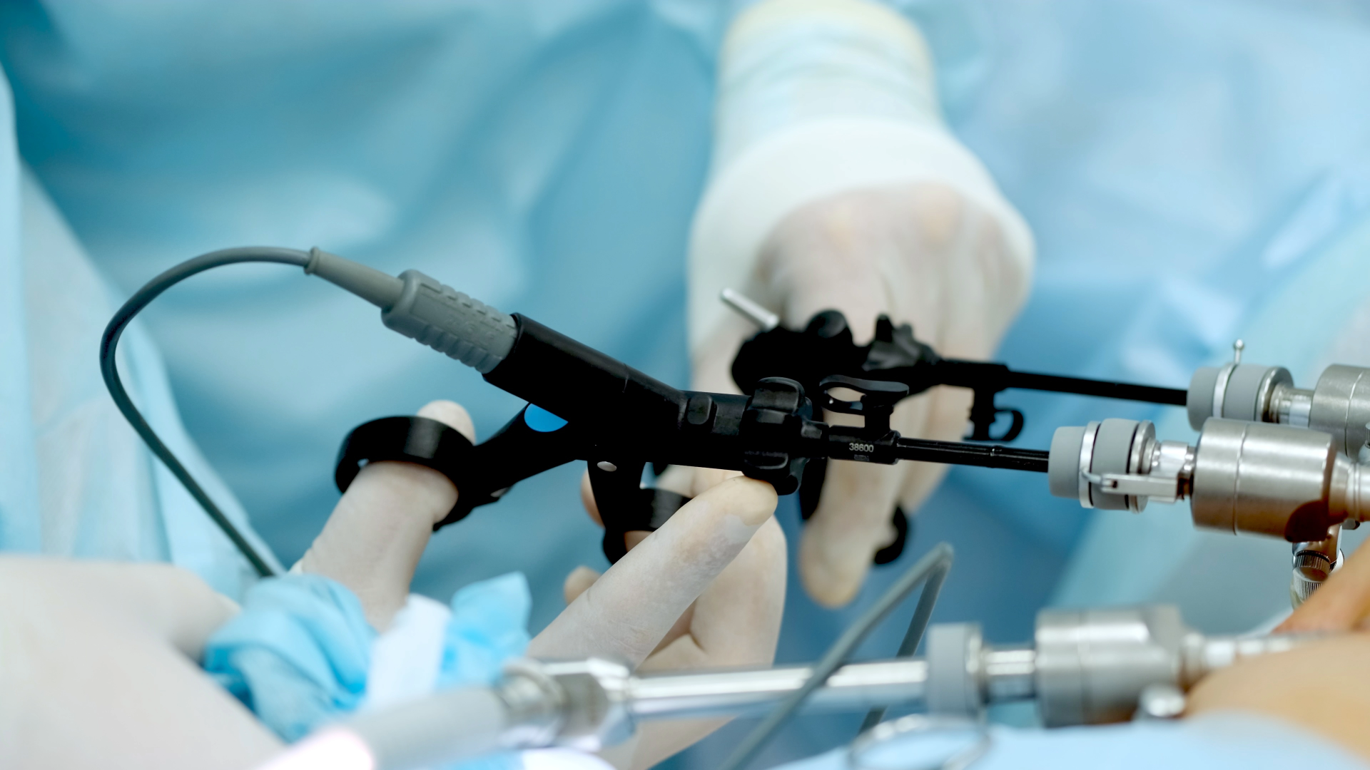 Close-up of a surgeon's hands handling surgical instruments during an operation in an operating room.
