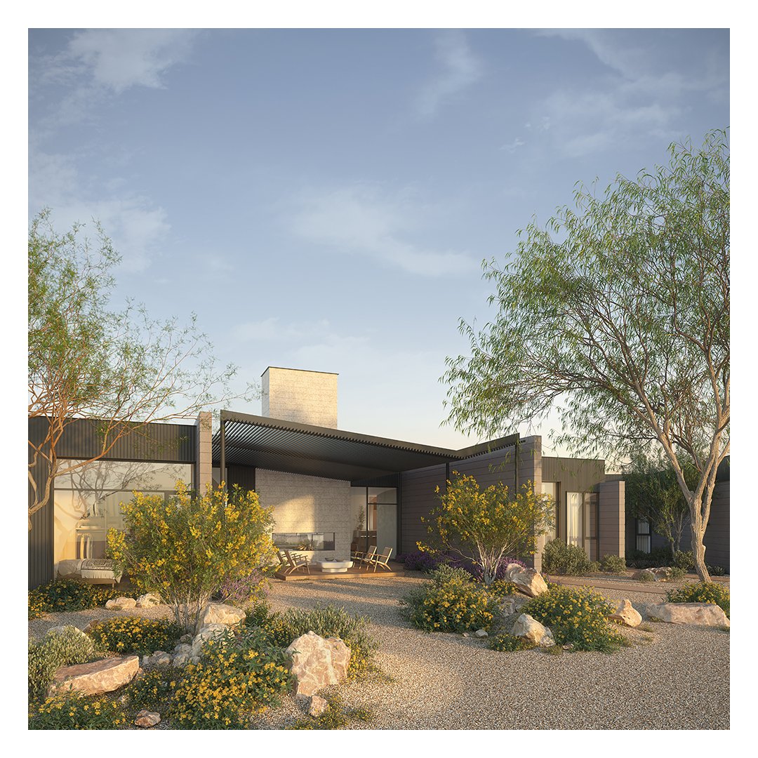 Modern house with outdoor seating area, surrounded by desert landscaping, trees, and rocks, under a clear blue sky.