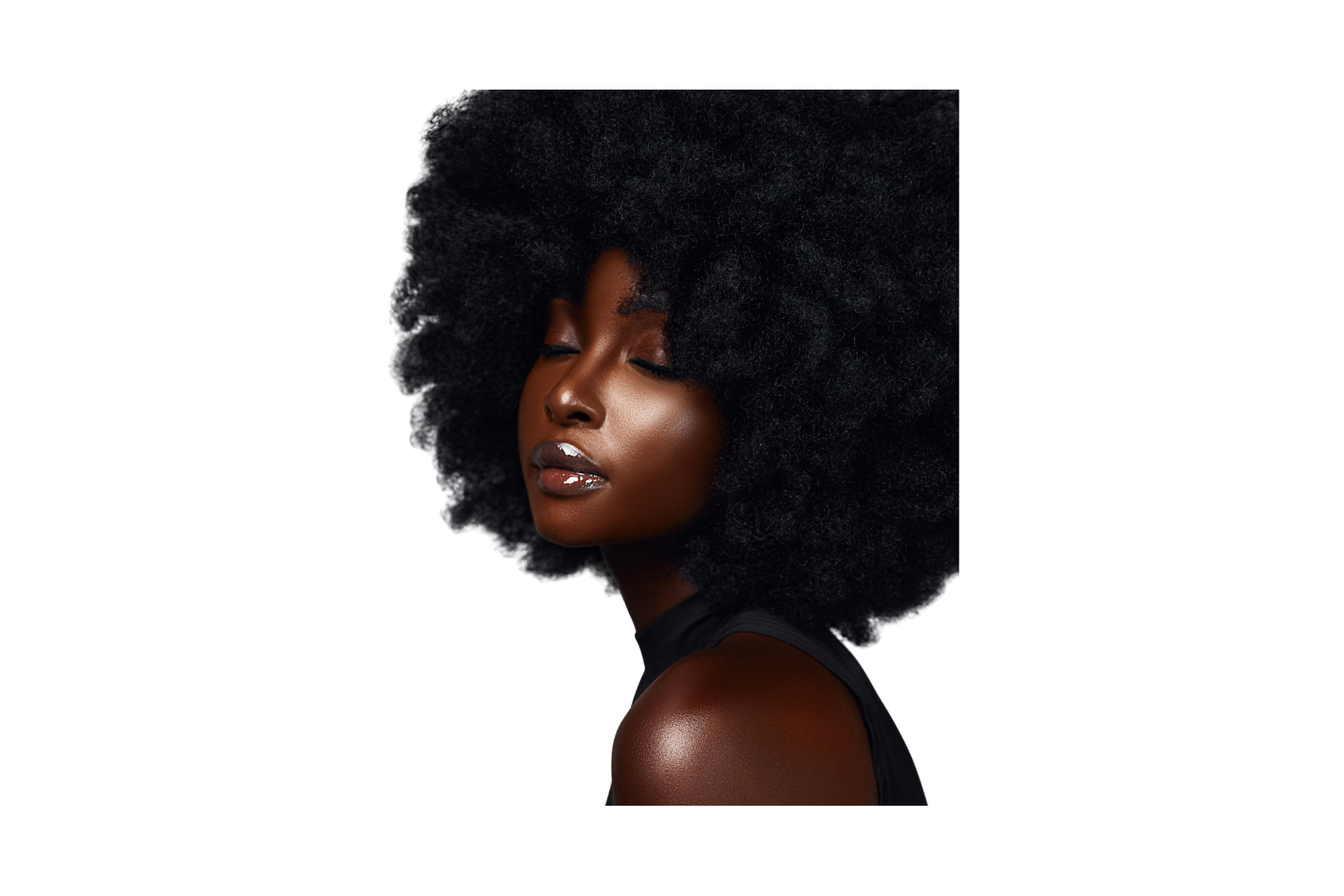 A profile of a woman with closed eyes and dark skin, wearing glossy lipstick and a sleeveless black top, with voluminous natural curly black hair.