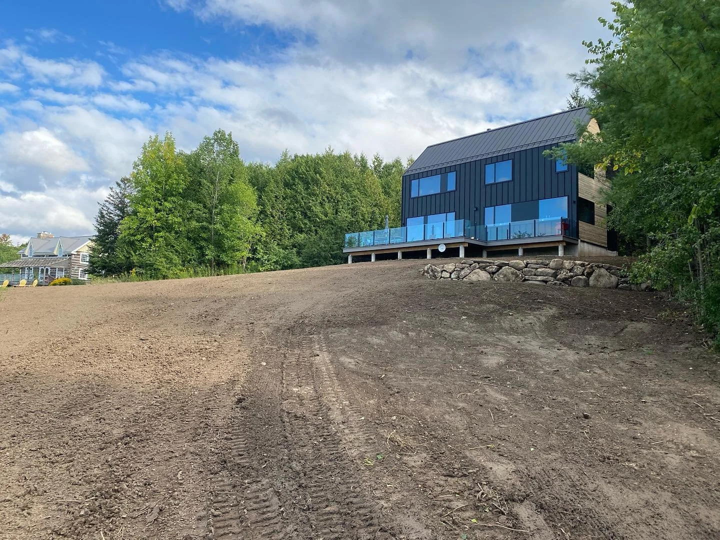 A before and after of a grading job and rock walls we completed last week.