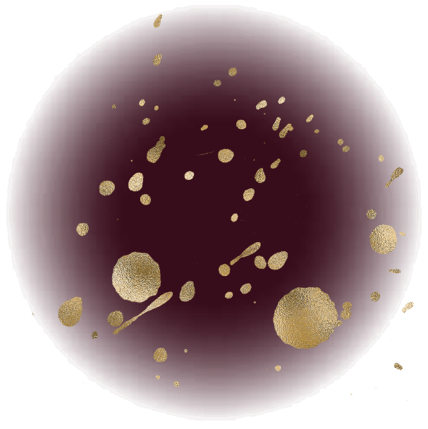 A dark spherical object with gold splatter patterns on its surface.