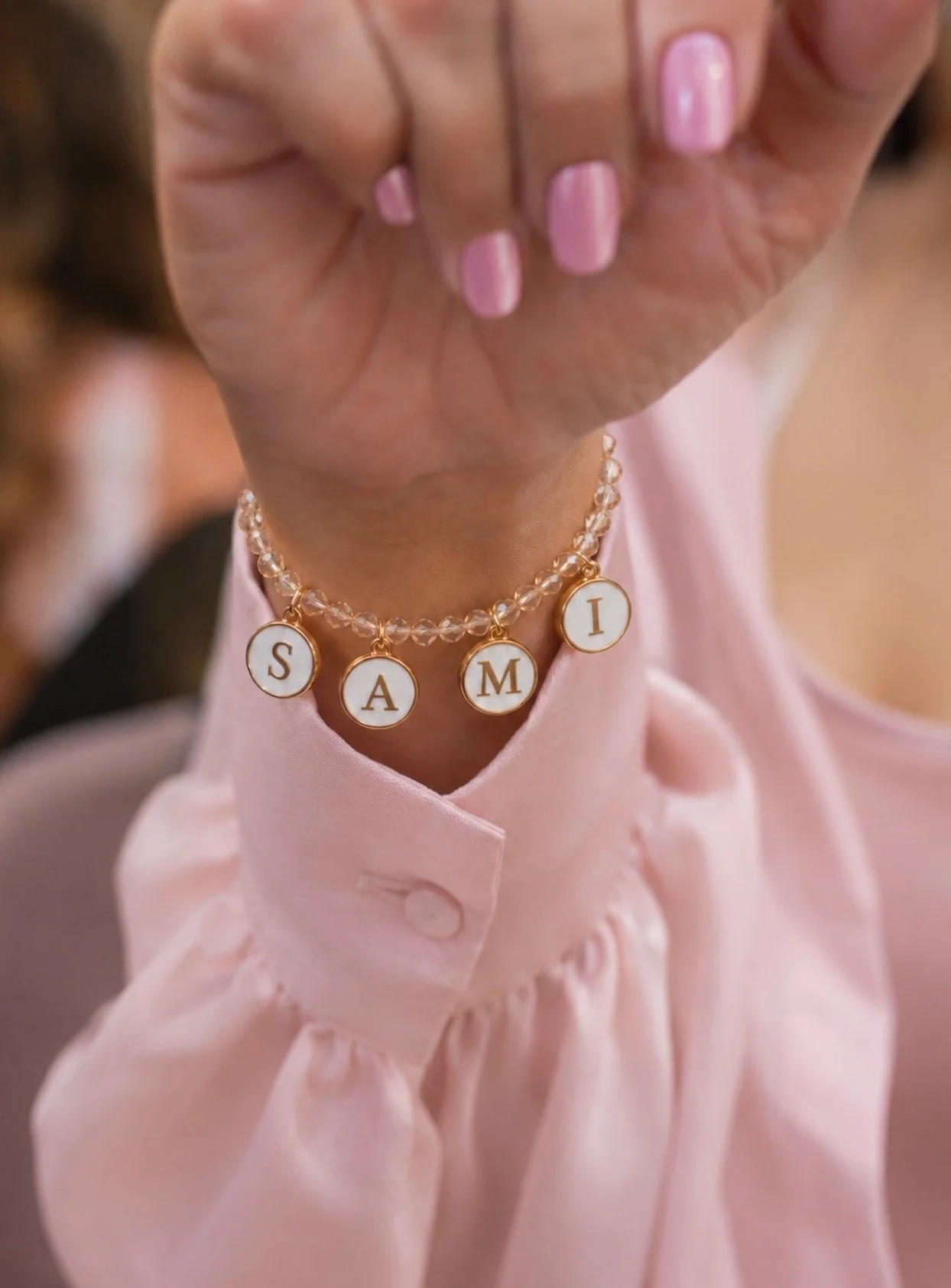 Blush & Bliss by Mya Charm Bar station featuring custom bracelet making for Bat Mitzvahs, Sweet 16s, and private events. Guests create personalized charm bracelets as a fun interactive activity and stylish party favor.
