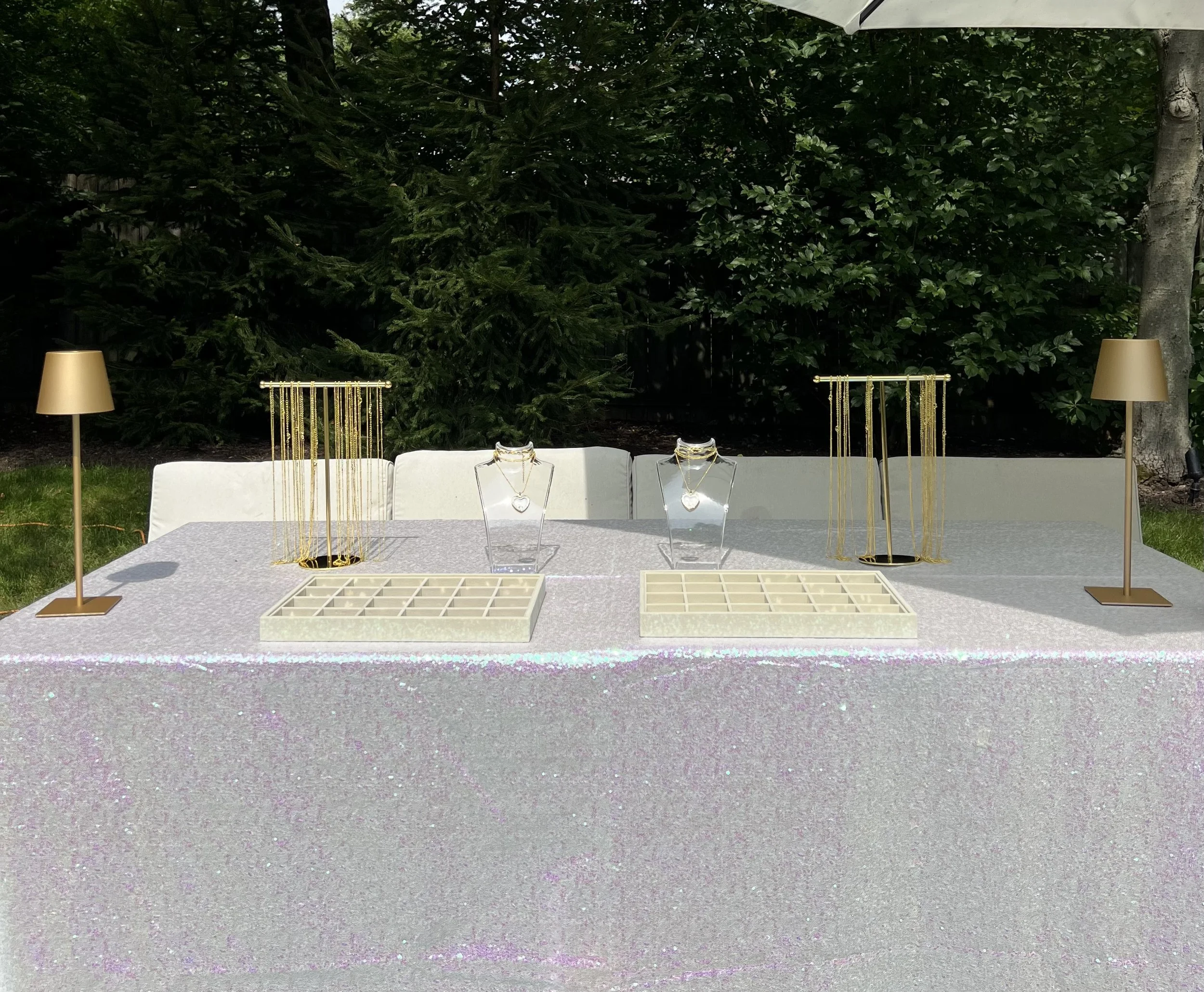 Elegant Floating Locket Bar setup by Blush & Bliss by Mya Interactive Entertainment featuring gold necklace displays, heart-shaped lockets, and miniature charms for Bat Mitzvahs, Sweet 16s, birthdays, and Chicago-area events.
