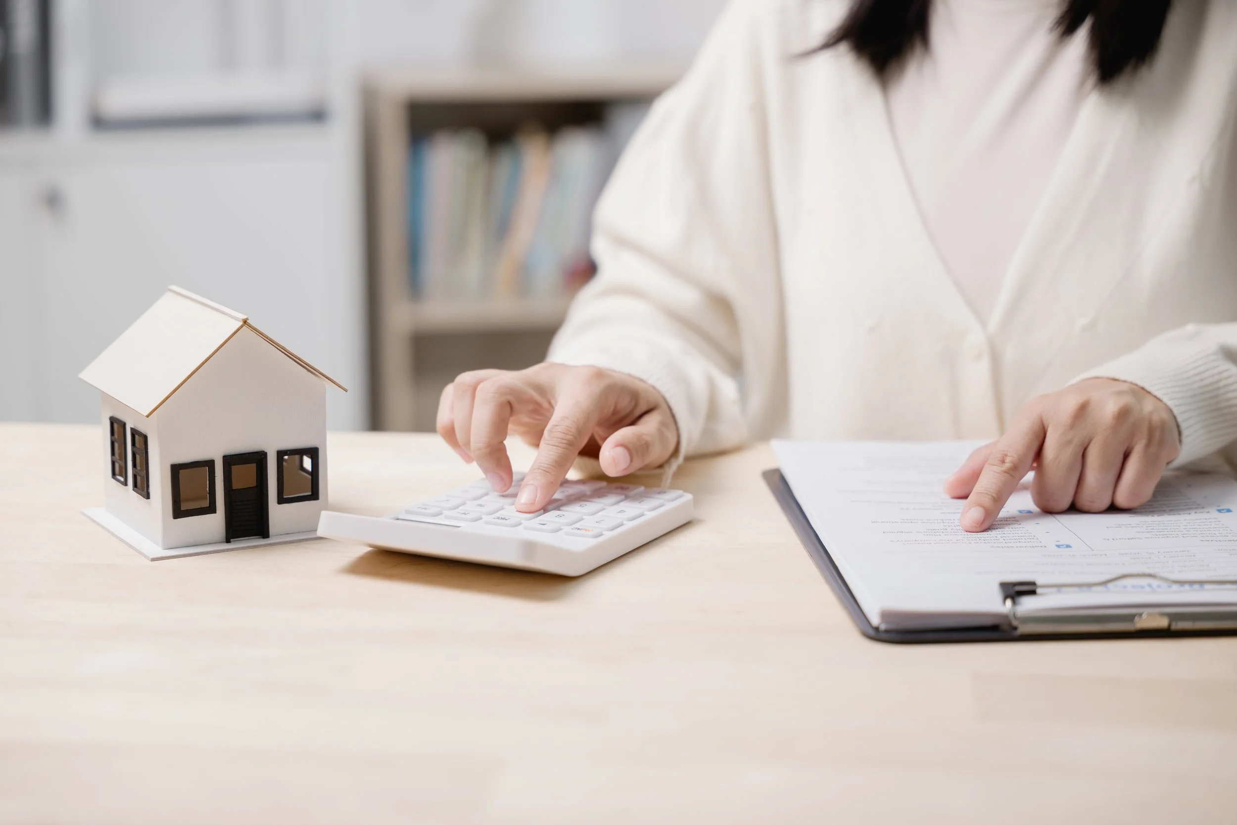 Person calculating out of pocket costs before insurance coverage begins