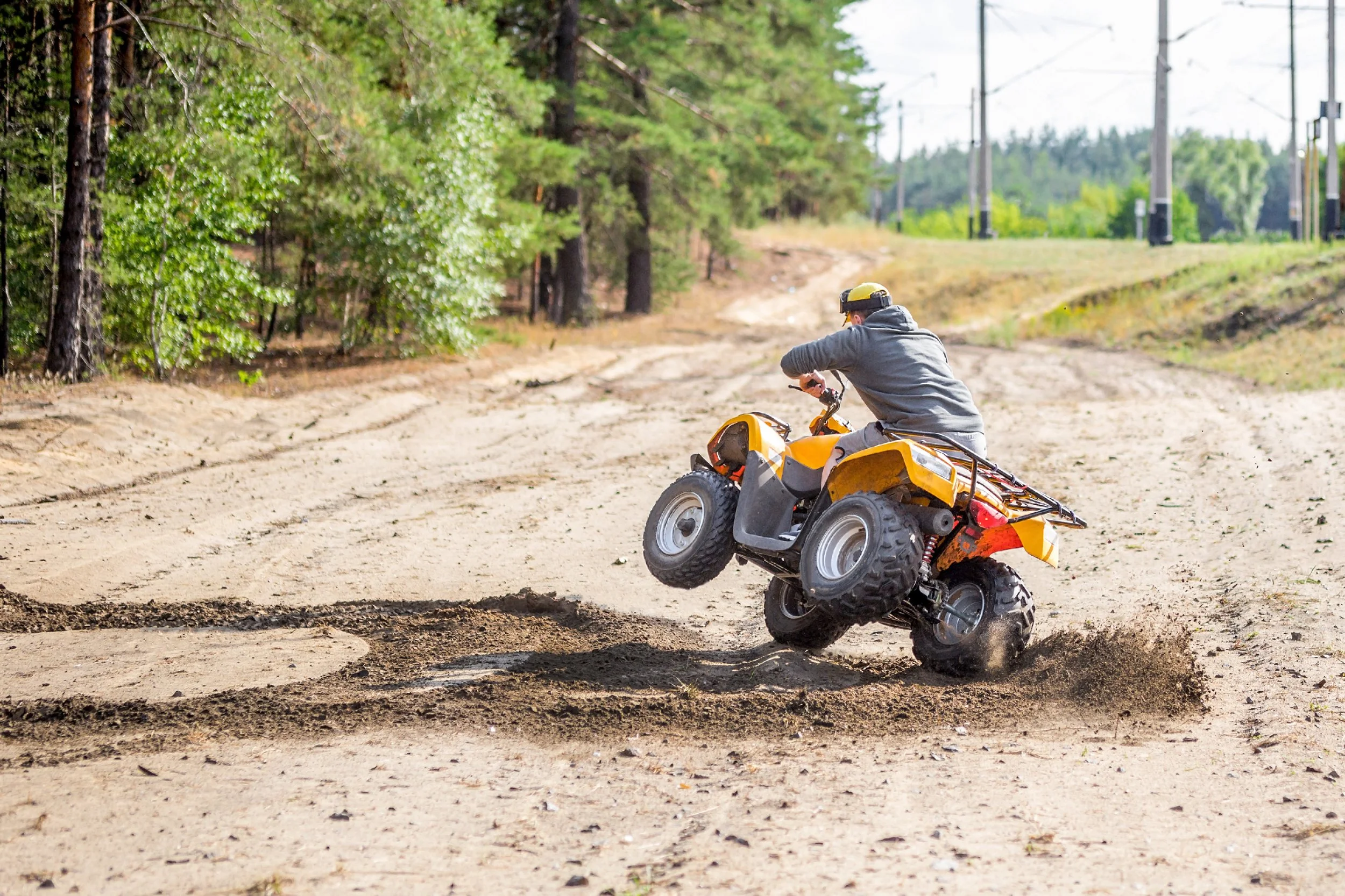 ATV rider navigating scenic Pennsylvania trail through wooded terrain