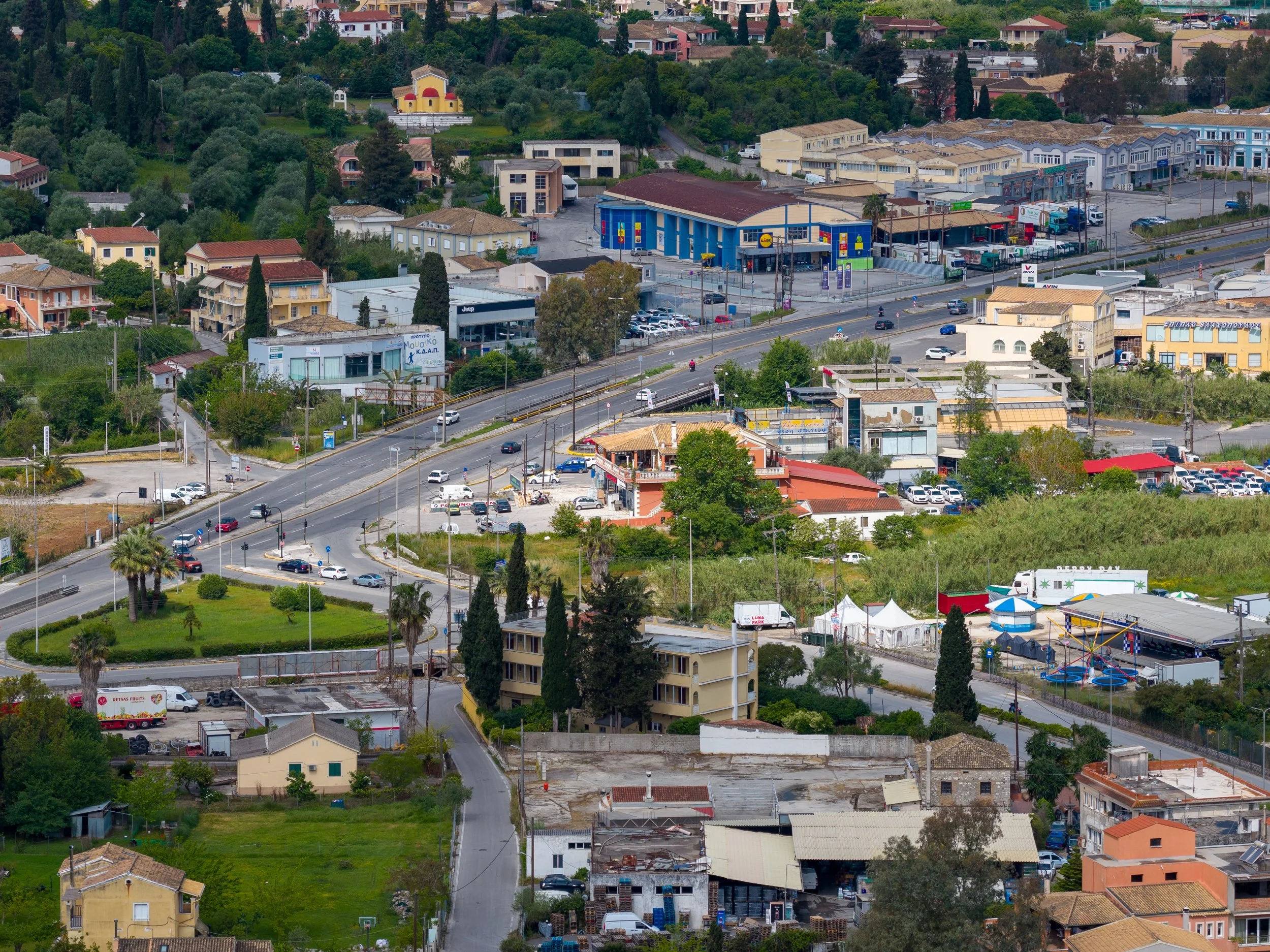 Traffic moving through a busy intersection where local claim activity affects insurance rates