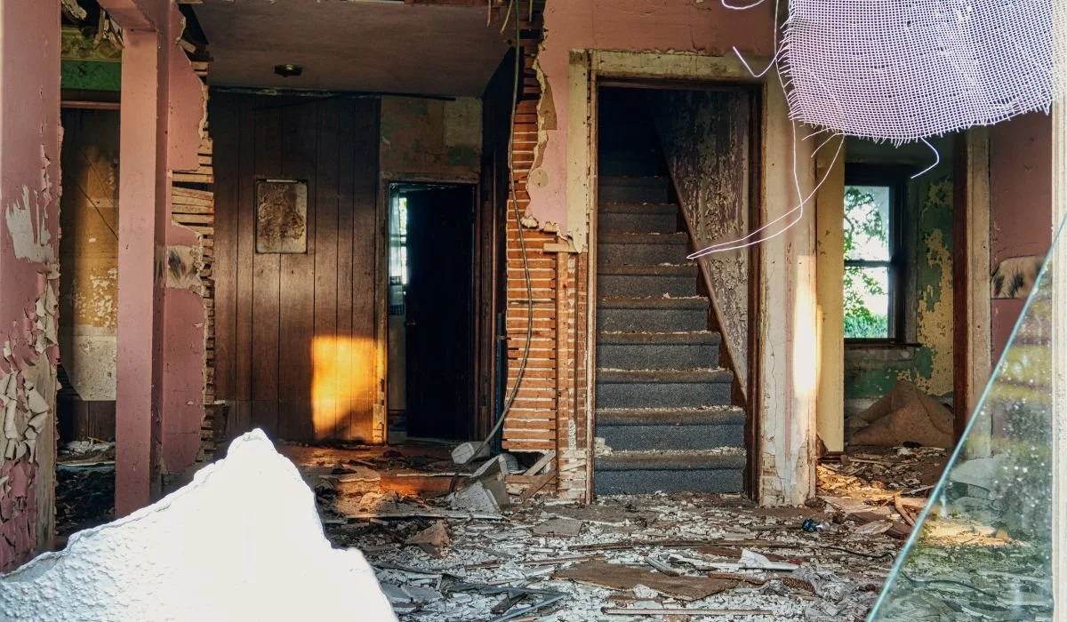 Homeowner reviewing interior property damage during an insurance claim