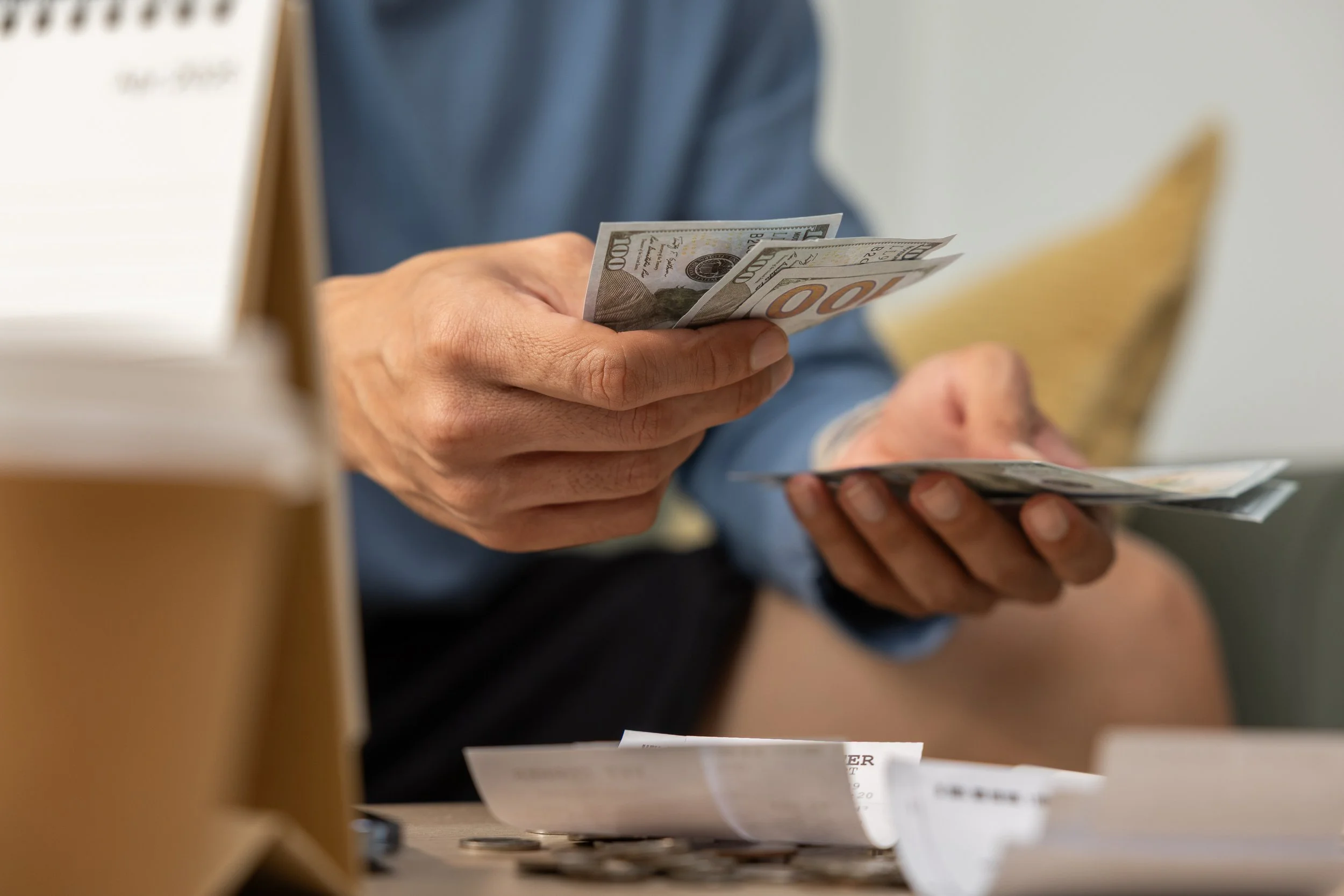 Person reviewing monthly premium costs that come with a low deductible plan
