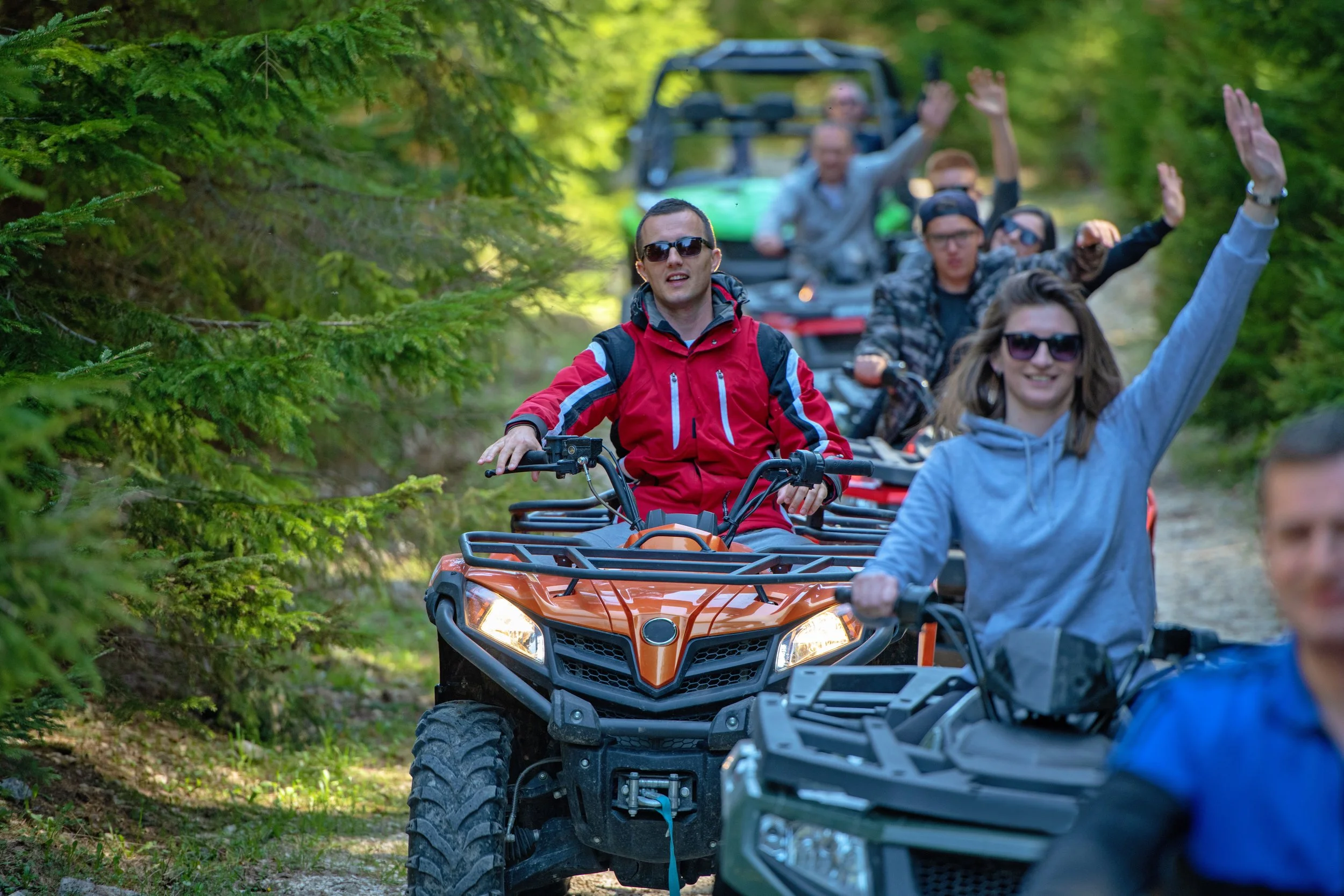 Group of ATVs and UTVs parked at trailhead ready for recreational riding