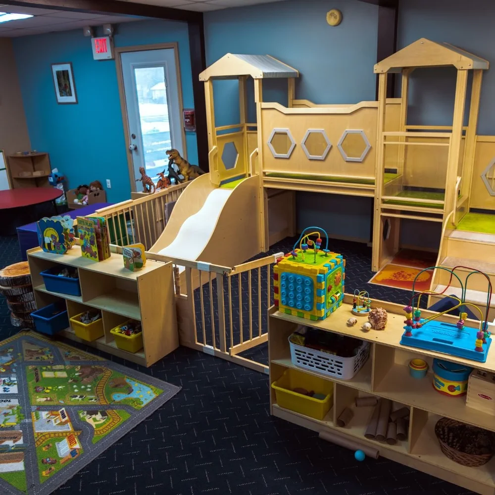 Toddler room with a wooden climbing loft and slide