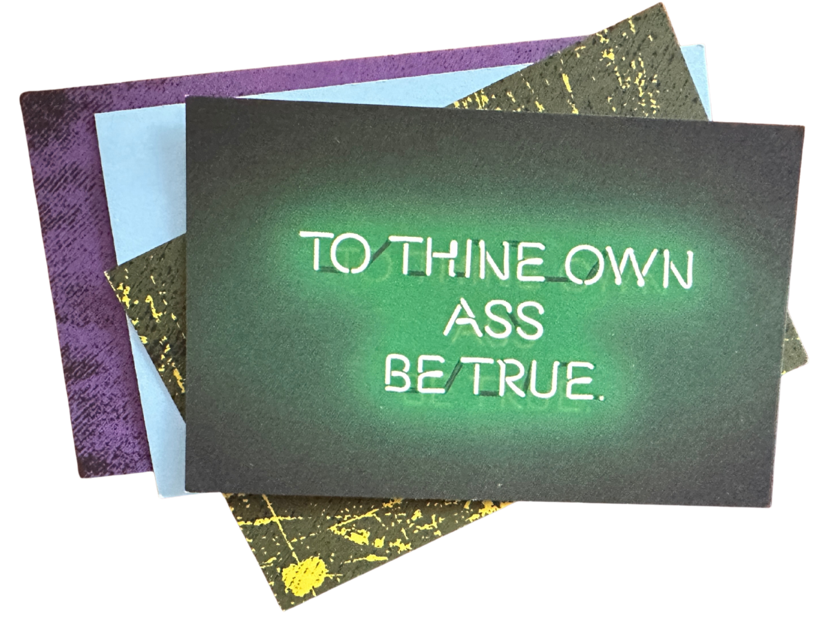 Neon sign with the words 'TO THINE OWN ASS BE TRUE' written in green on a black background, layered on top of colorful textured cards.