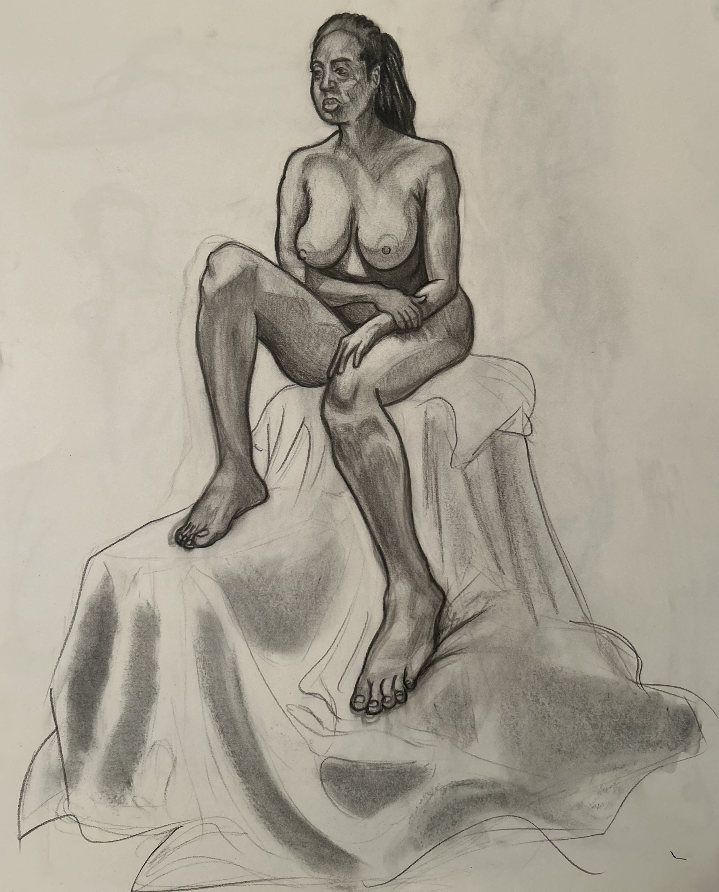 Charcoal drawing of a nude woman seated on fabric