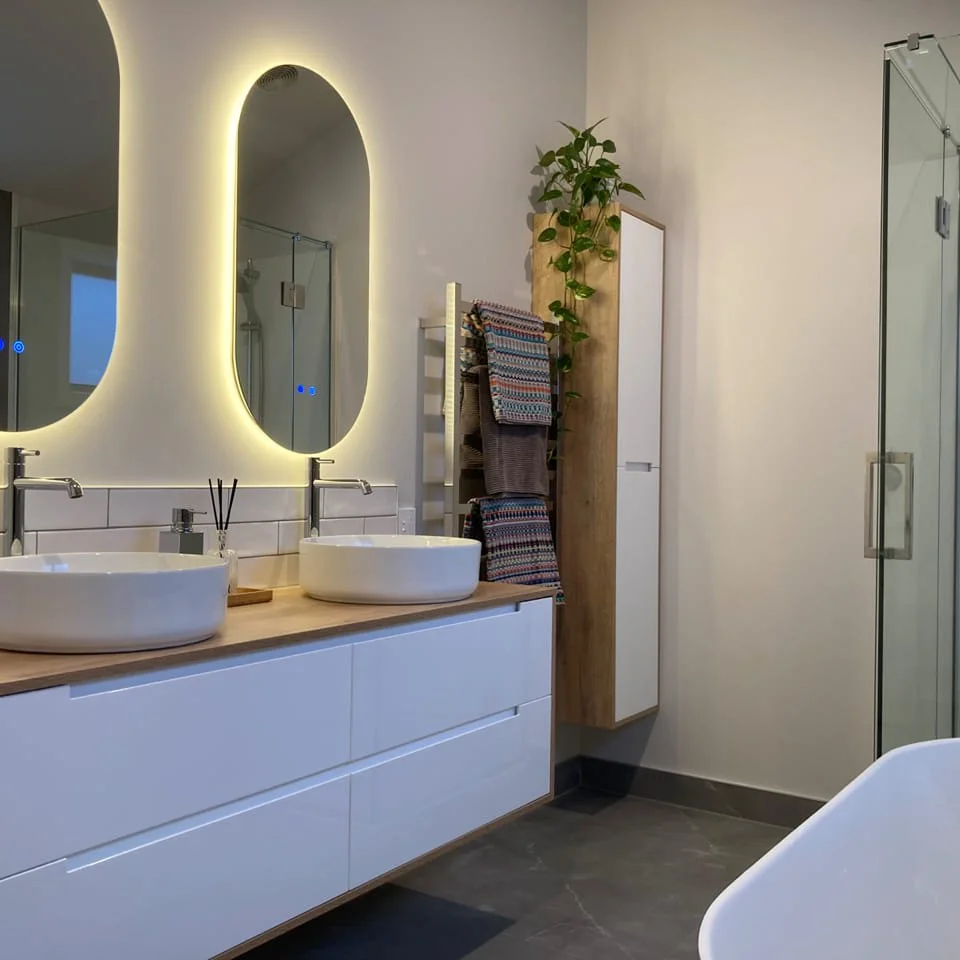 Modern bathroom renovation with double sinks.