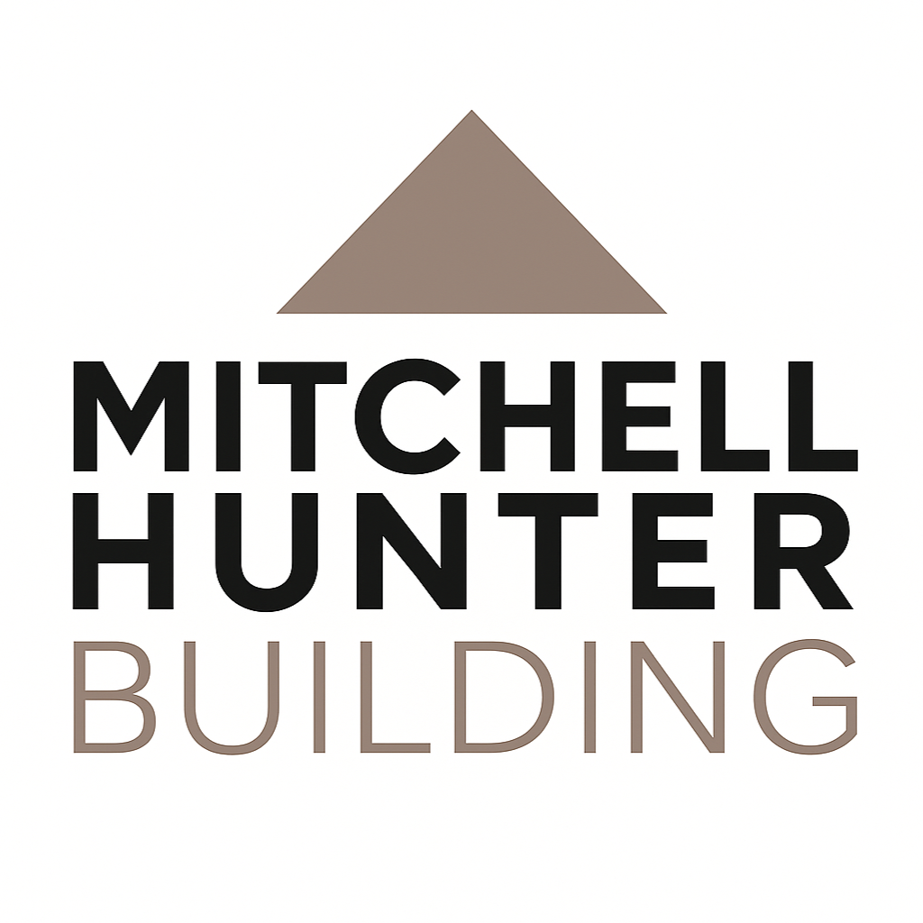 Logo for Mitchell Hunter Building featuring a brown triangle above the black text 'MITCHELL HUNTER' with the word 'BUILDING' in light brown below.