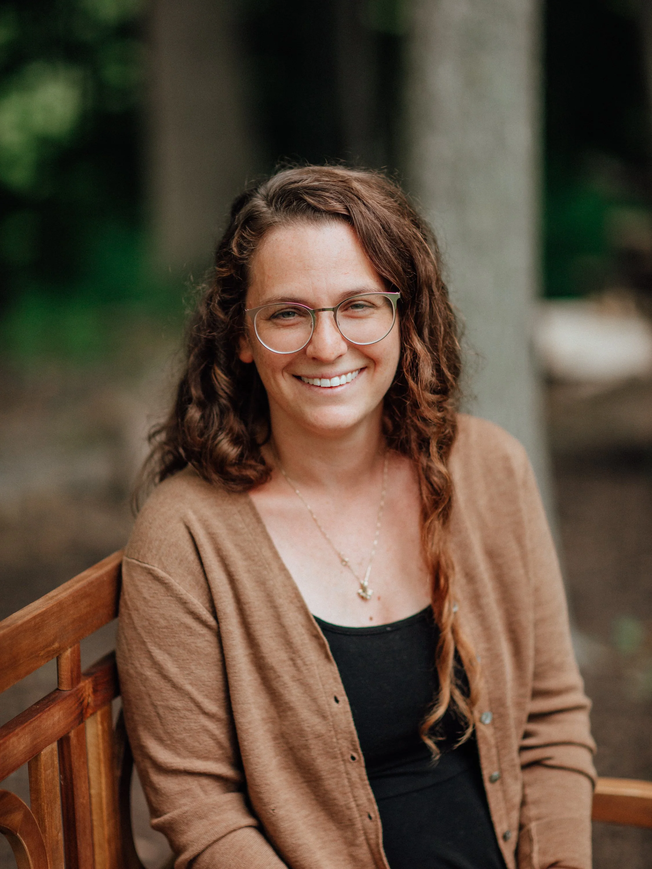 An Oval Photo of a Smiling Woman Wearing Glasses