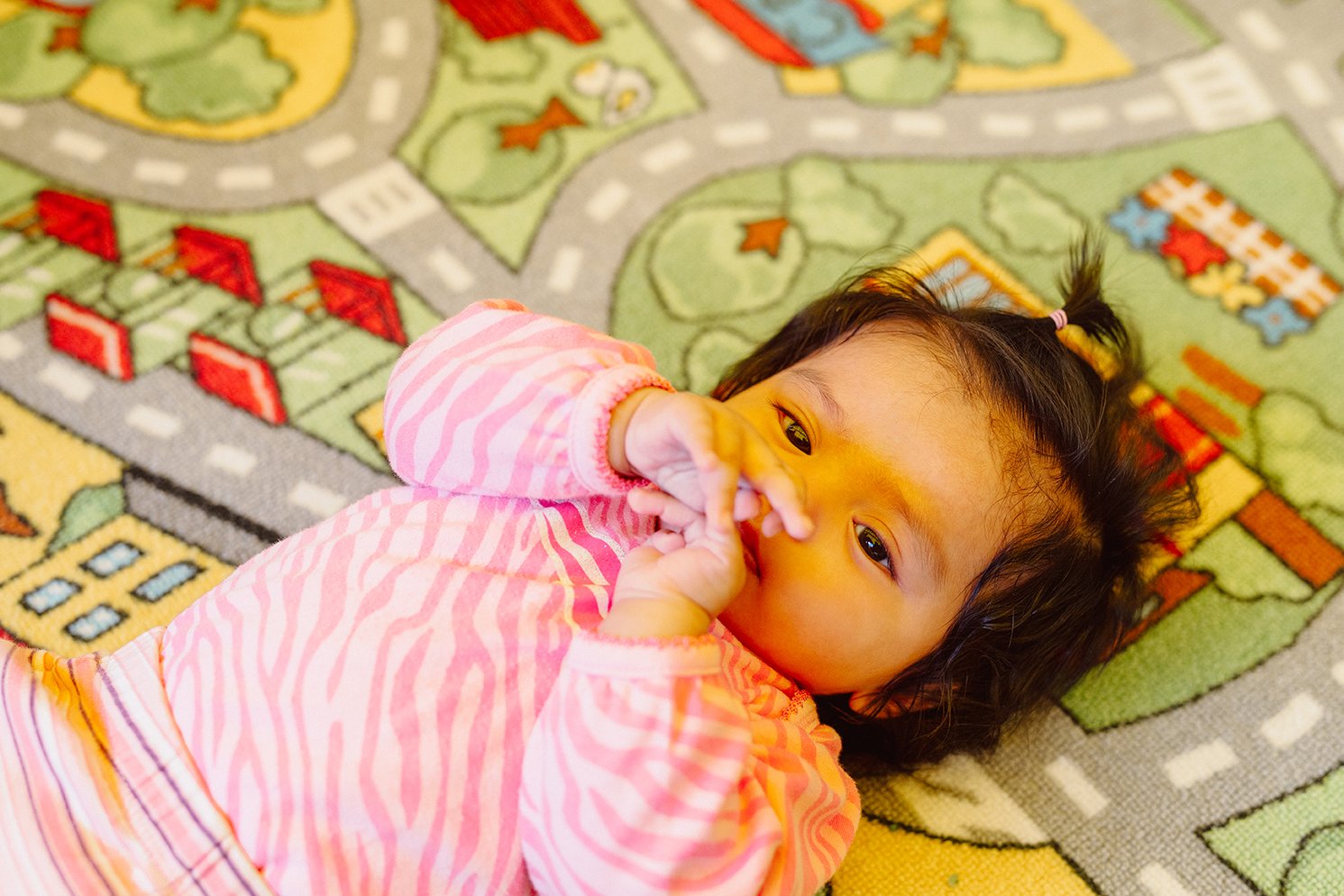 Infant laying on the rug