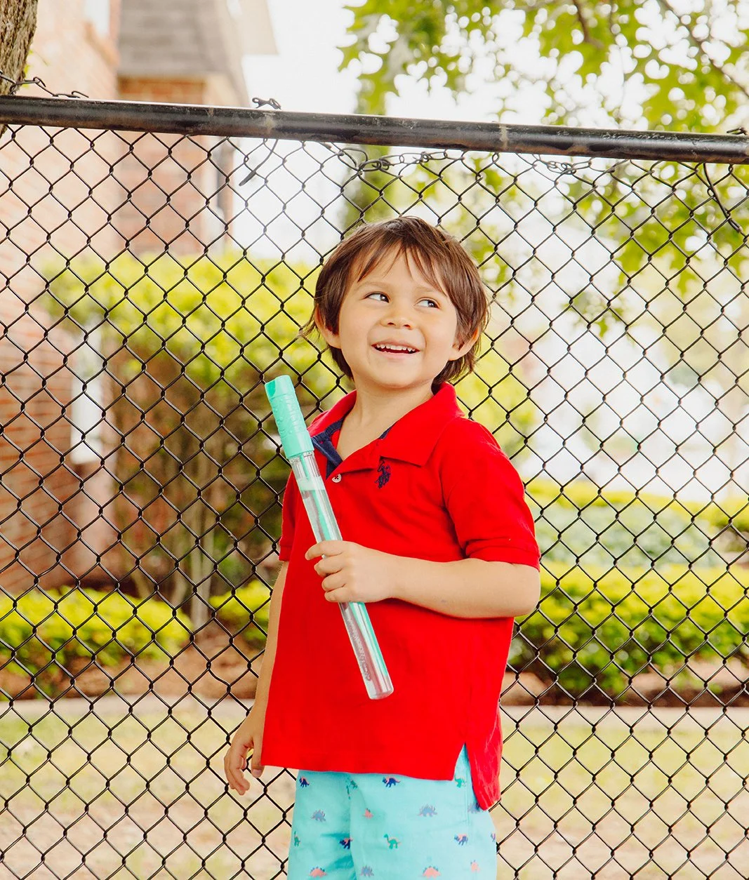 Boy playing with bubbles outside