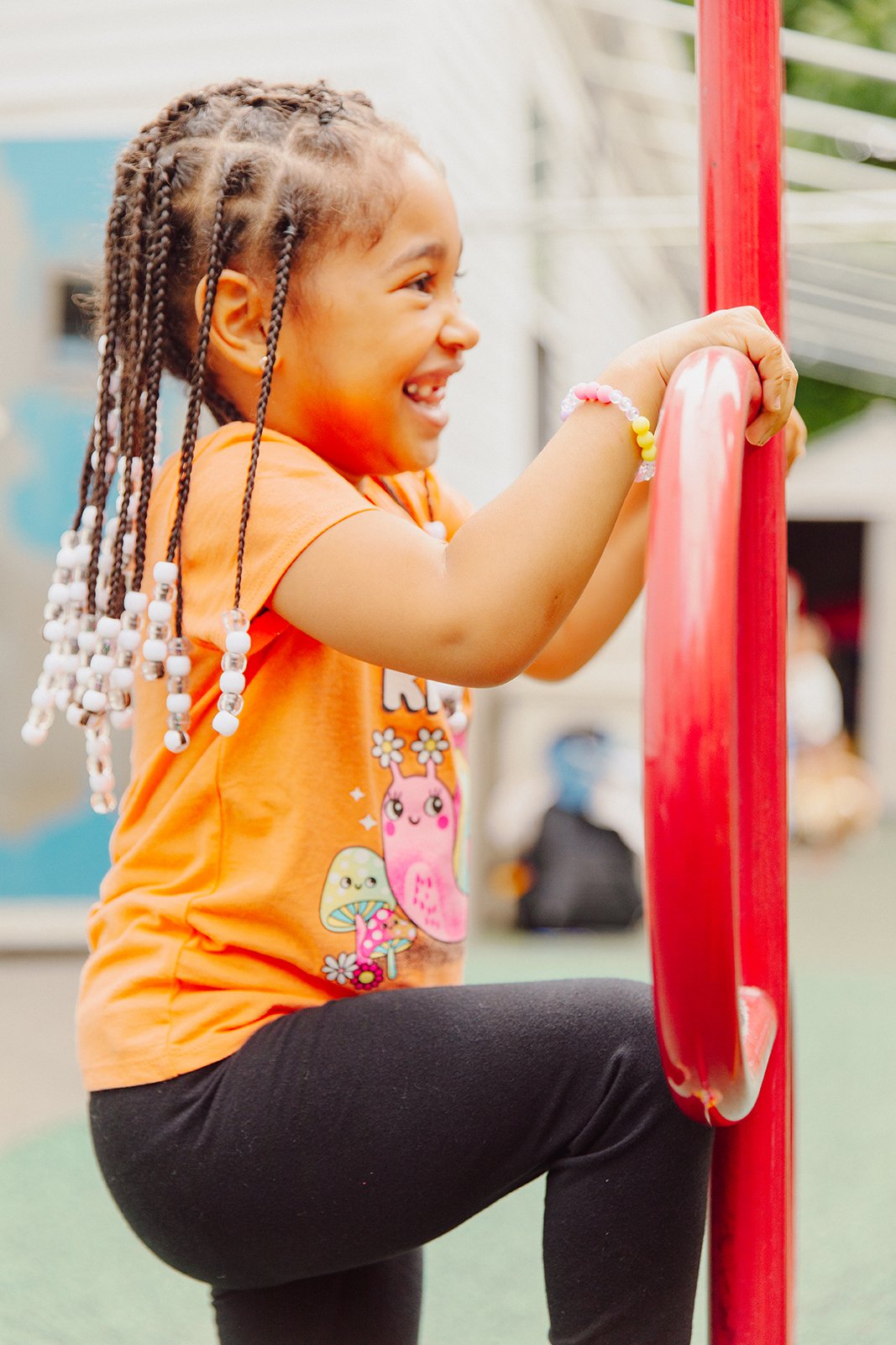 Girl playing outside on jungle gym