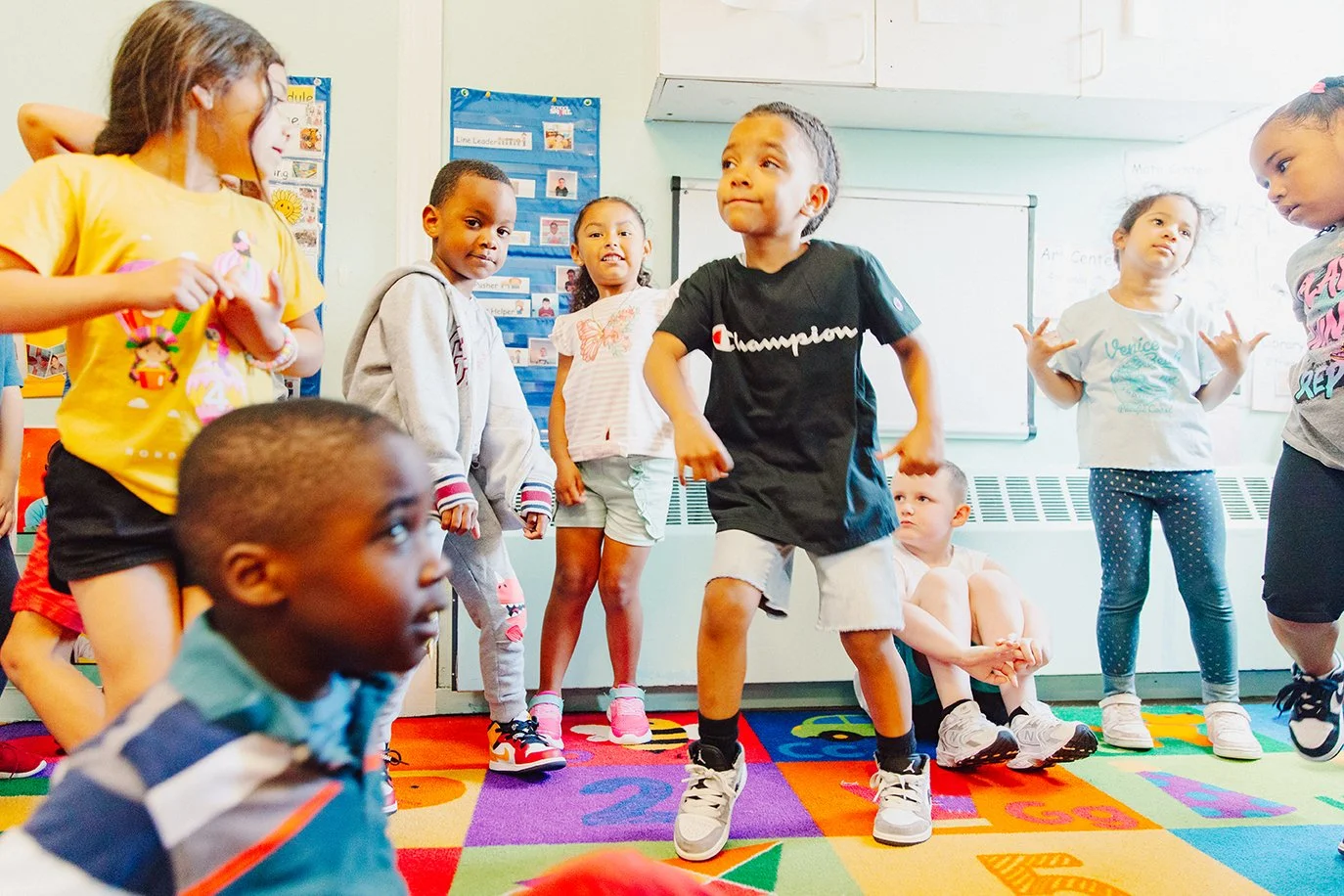 Kids playing and jumping on rug