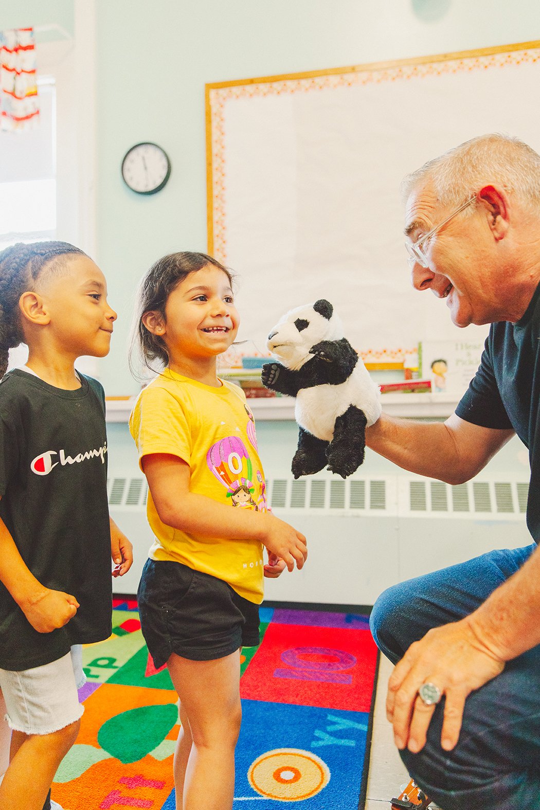 Worker showing kids a puppet