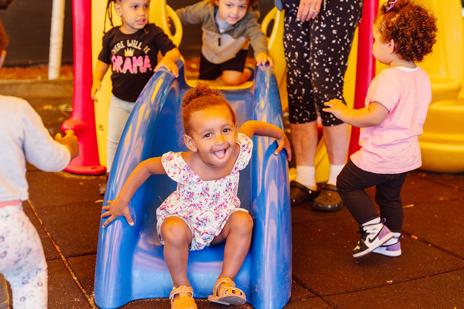 Toddlers playing outside on jungle gym