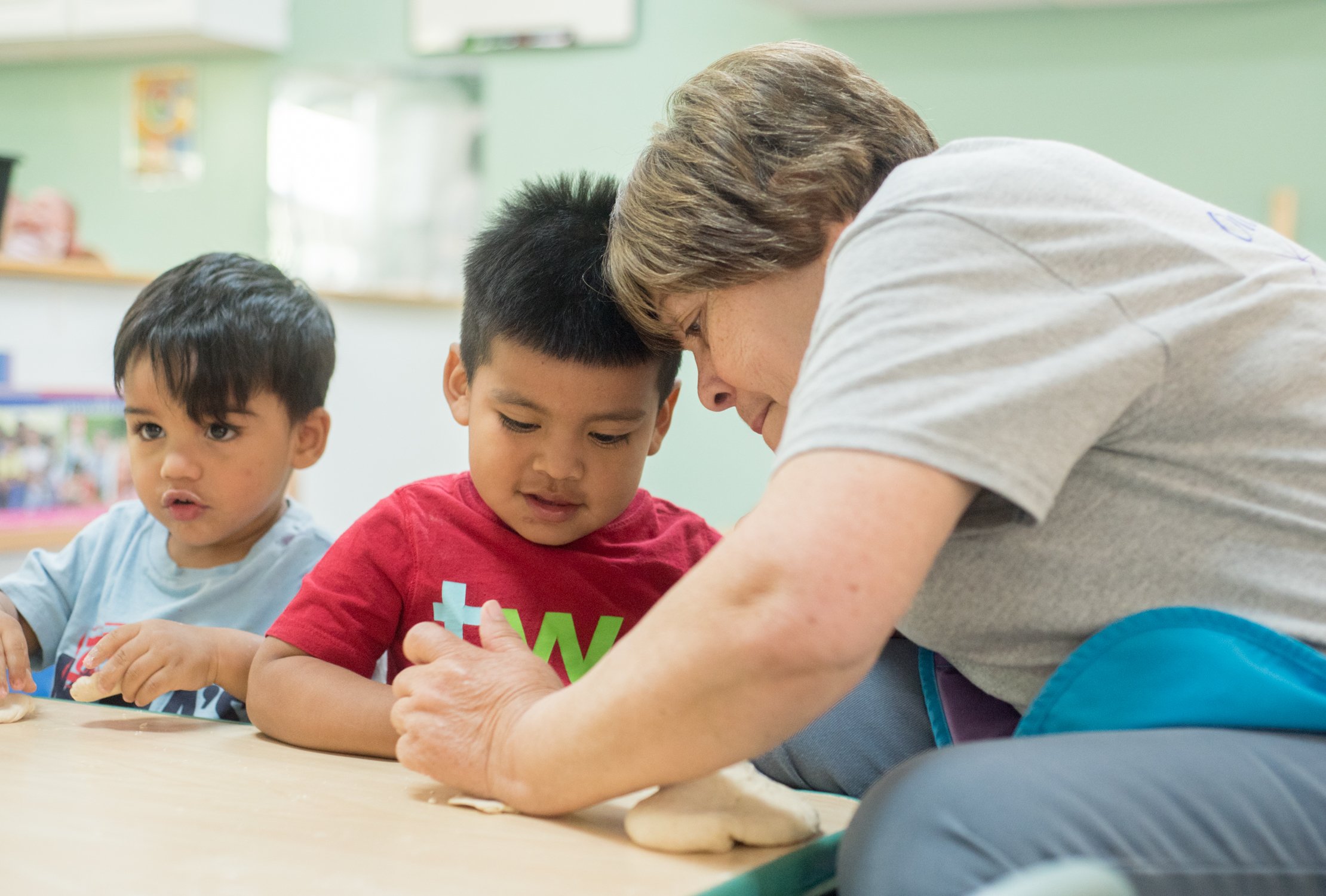 Gregg House worker helping toddler