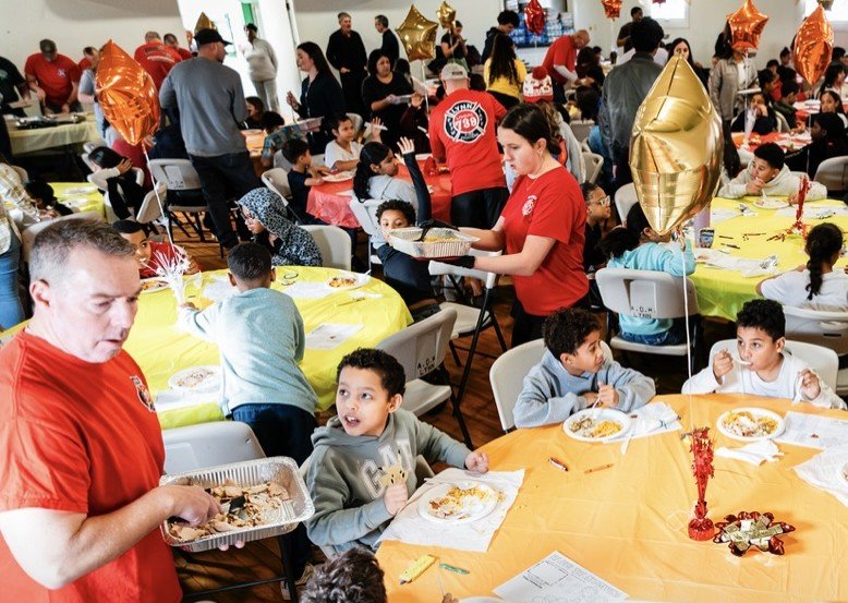 Firefighters serving the kids lunch