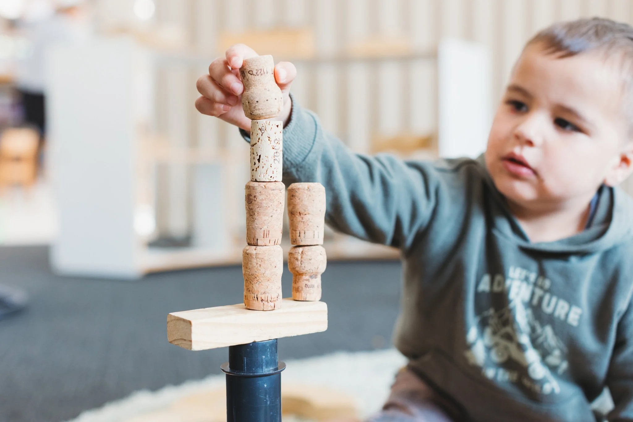 Little boy stacking toys at highly rated Mangere childcare