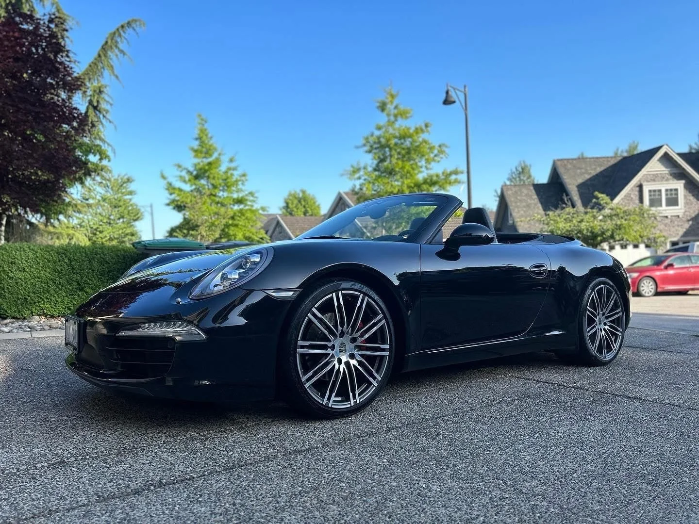 Black convertible sports car with flawless paint correction