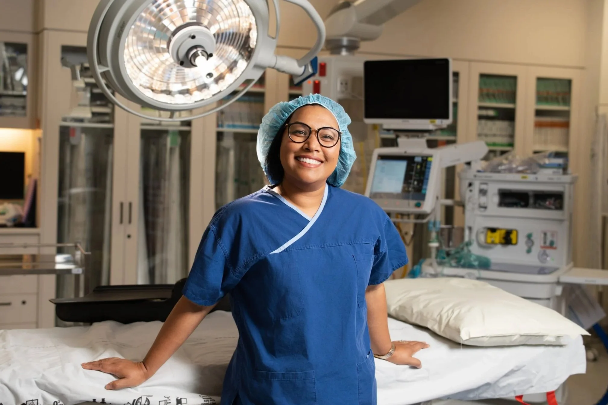 Dr Atandrila Das, Melbourne colorectal and general surgeon, smiling in theatre scrubs at Northern Private Hospital