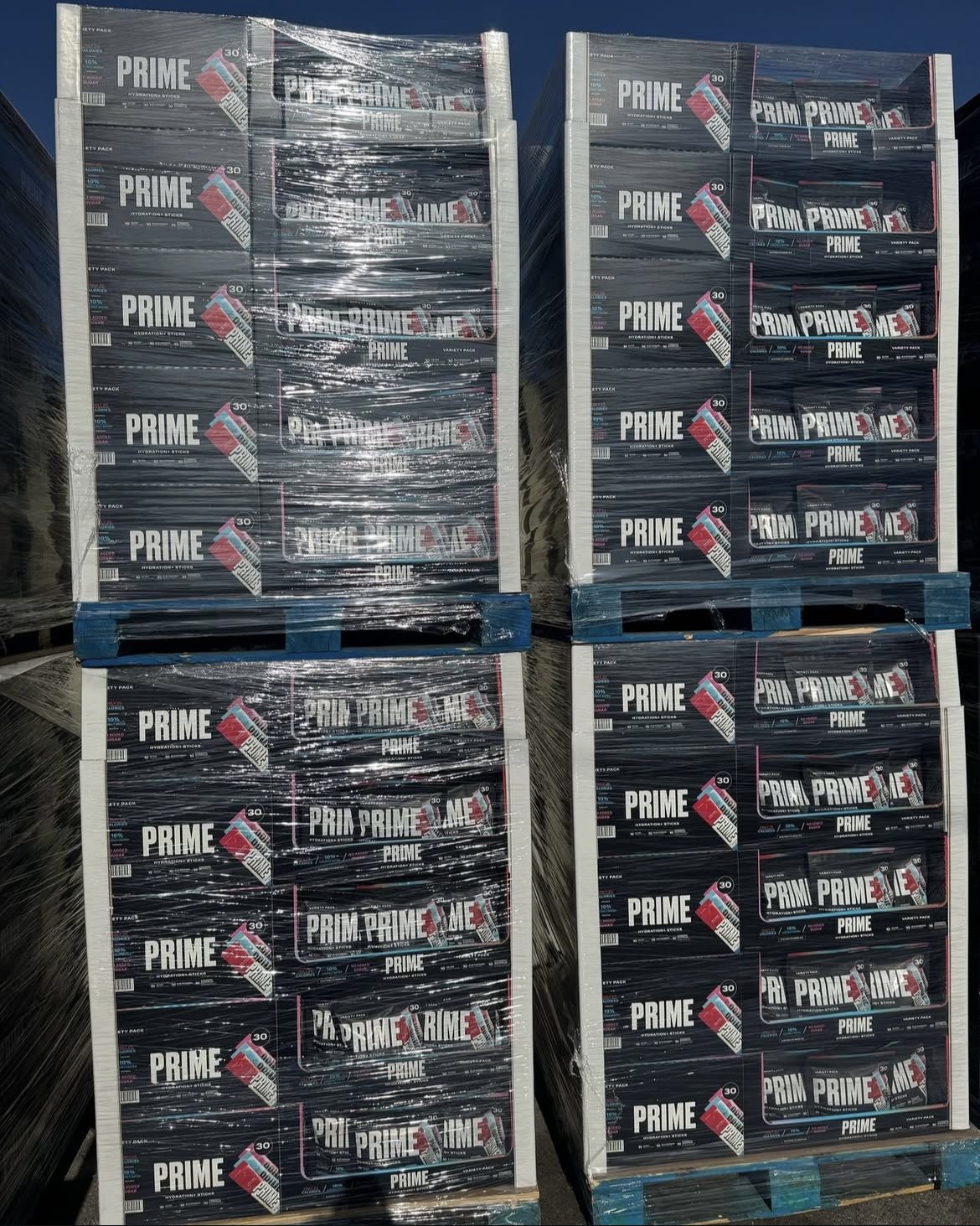 Pallets stacked with boxes labeled 'Prime' and wrapped in plastic.