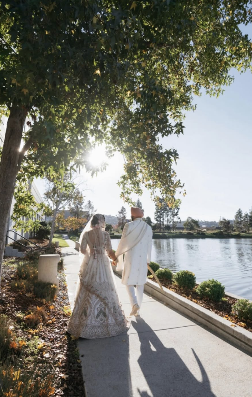 Table with floral centerpiece, candles, lemons, and glasses for an outdoor setting.