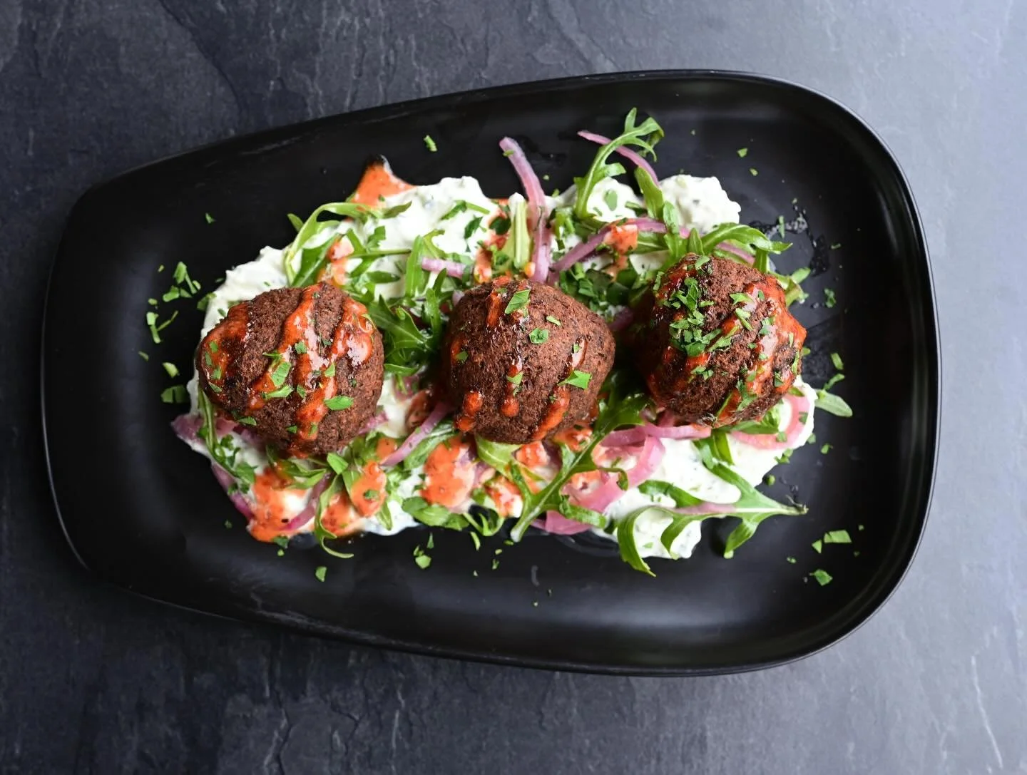 Our newest menu addition ✨
Falafel served over house-made tzatziki, paired with an arugula salad tossed in citrus vinaigrette, and finished with a chipotle pepper jam aioli. 🤌🏼

Available now for lunch &amp; dinner!