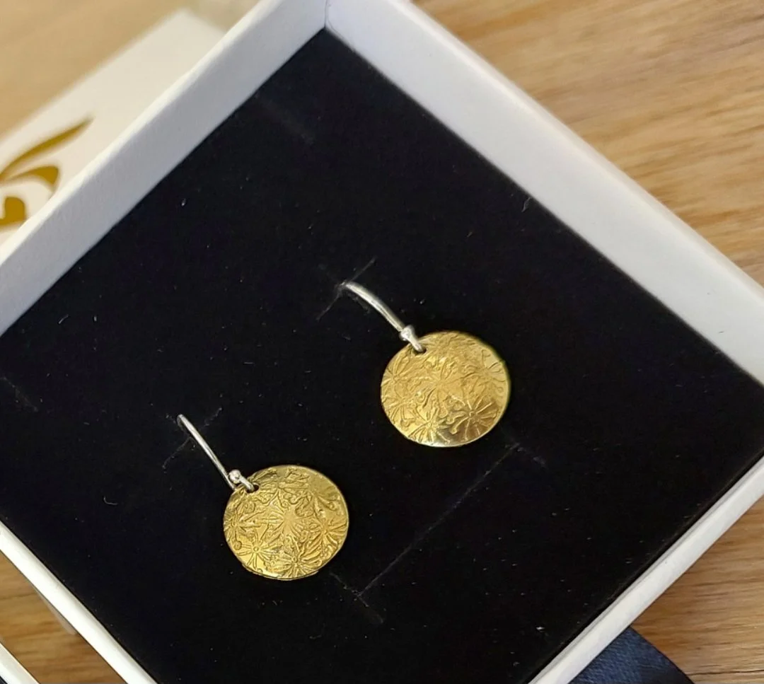 Brass earrings made in a corporate wellbeing workshop with Sarah Munnings