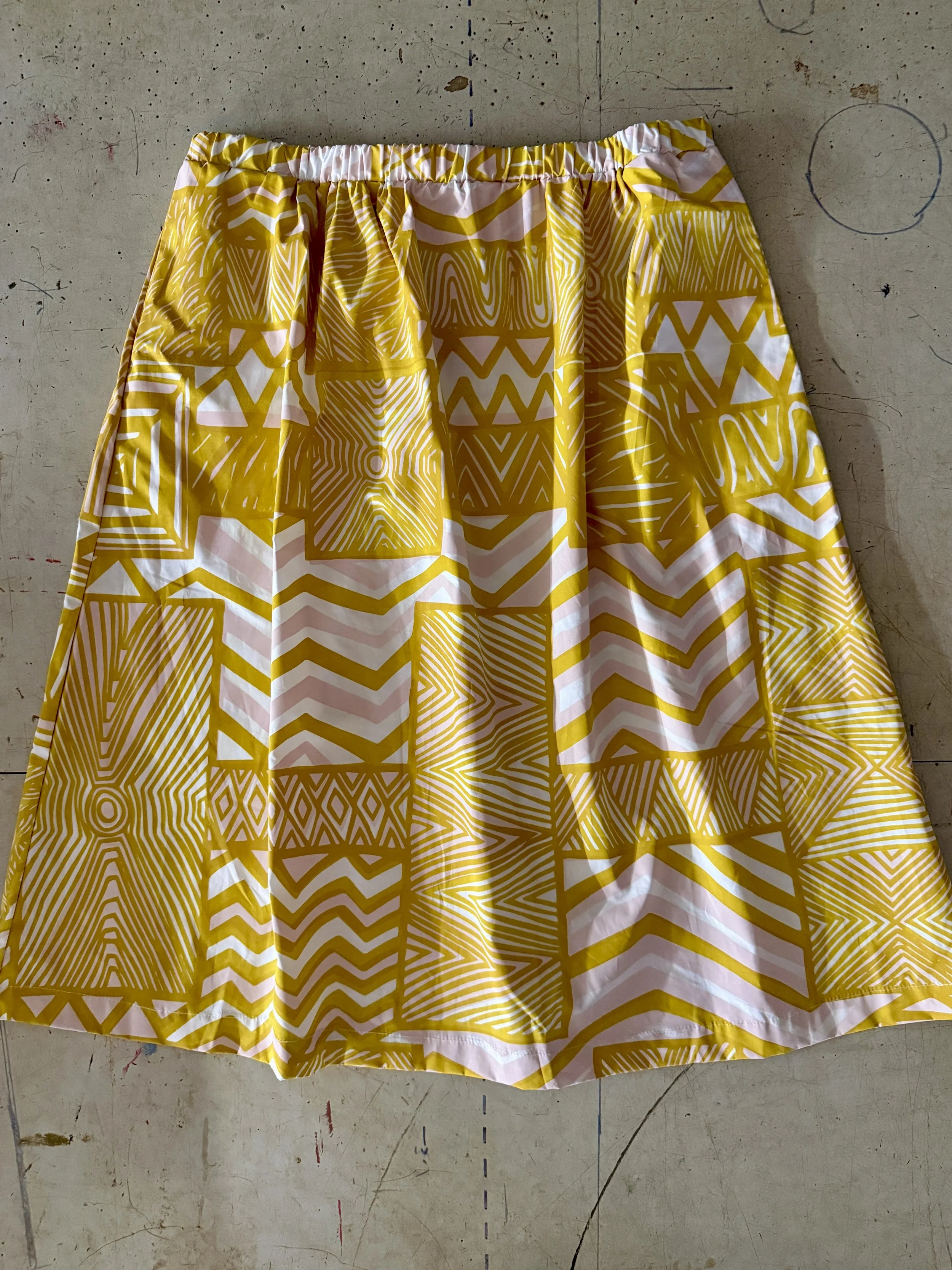 Cotton poplin skirt with yellow and pink pukamani print.jpg