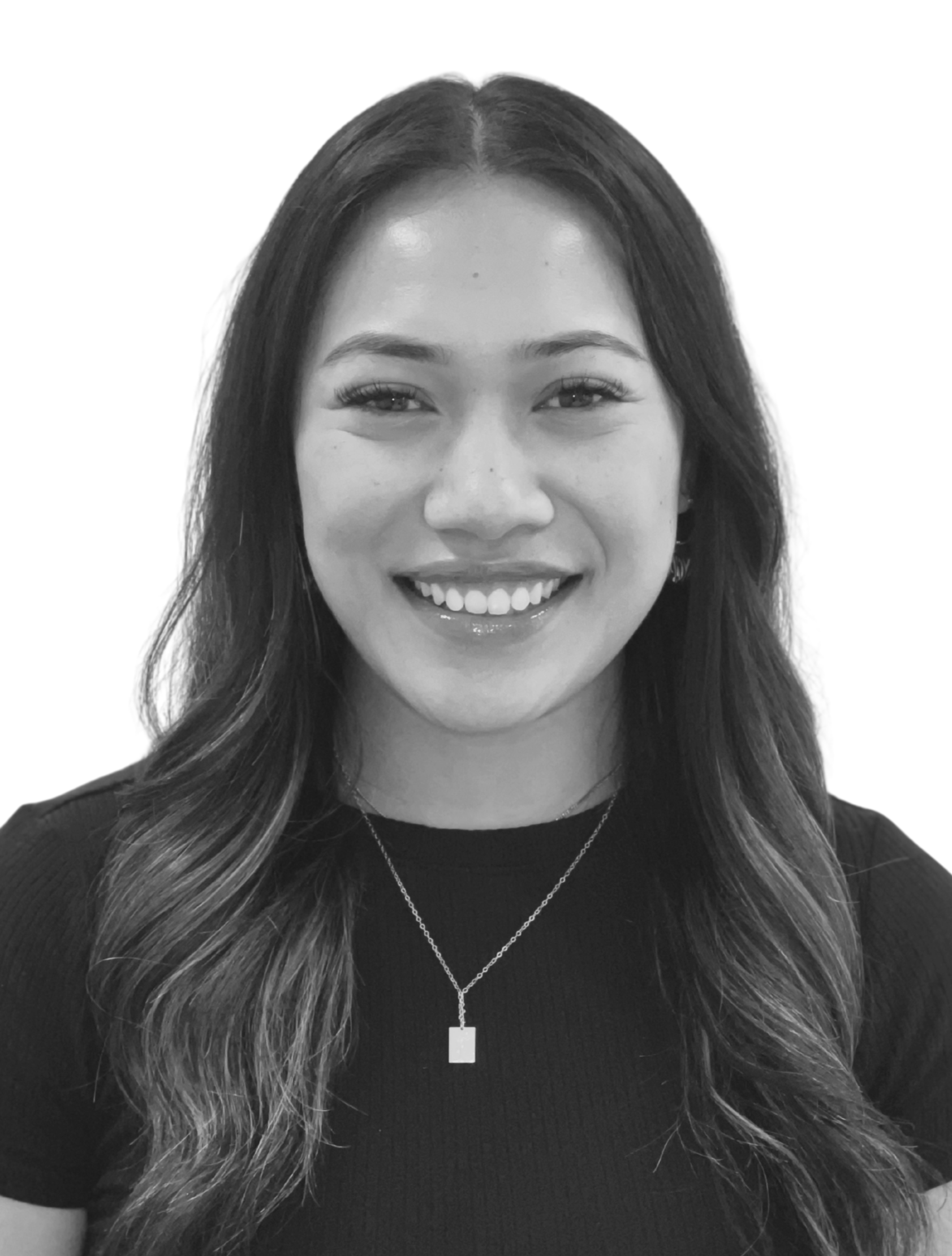 Black and white headshot of a woman with dark hair, wearing a blazer and a collared shirt, smiling slightly