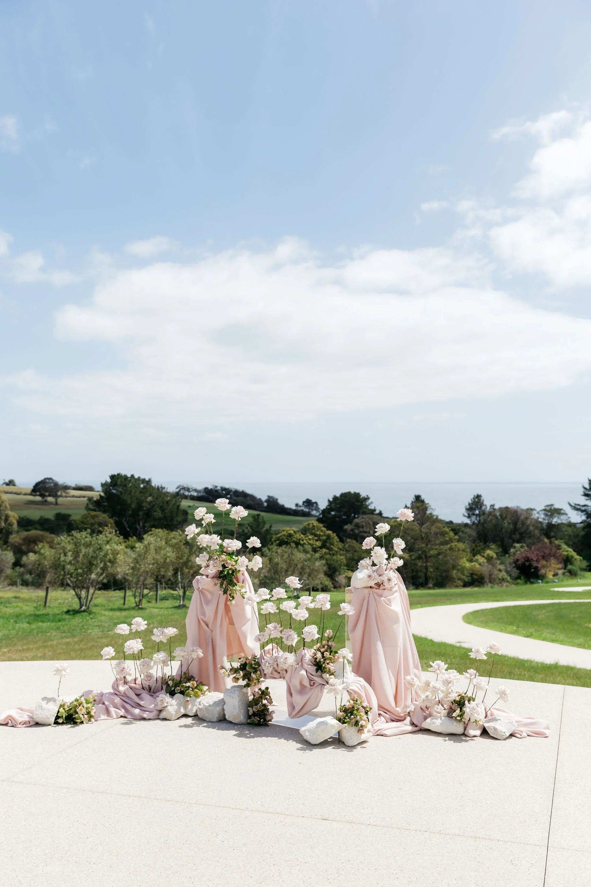 Sunnyside Estate wedding ceremony styling with blush draping and romantic pink and white floral arrangements.