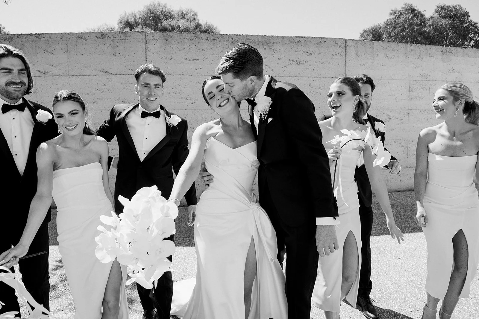 Wedding party portrait at Port Phillip Estate with the bride holding a white orchid bouquet.