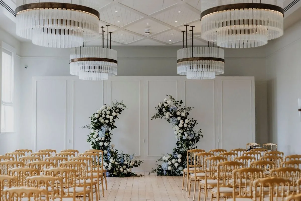 InterContinental Sorrento ceremony styling with modern circular floral arrangements in white and soft blue.
