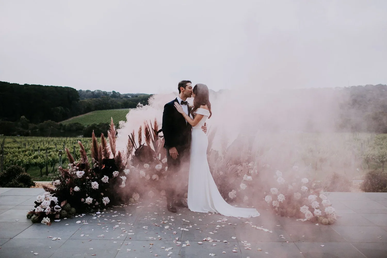 Jackalope vineyard wedding with romantic pink smoke and Poppy Culture’s blush and white floral arrangements.