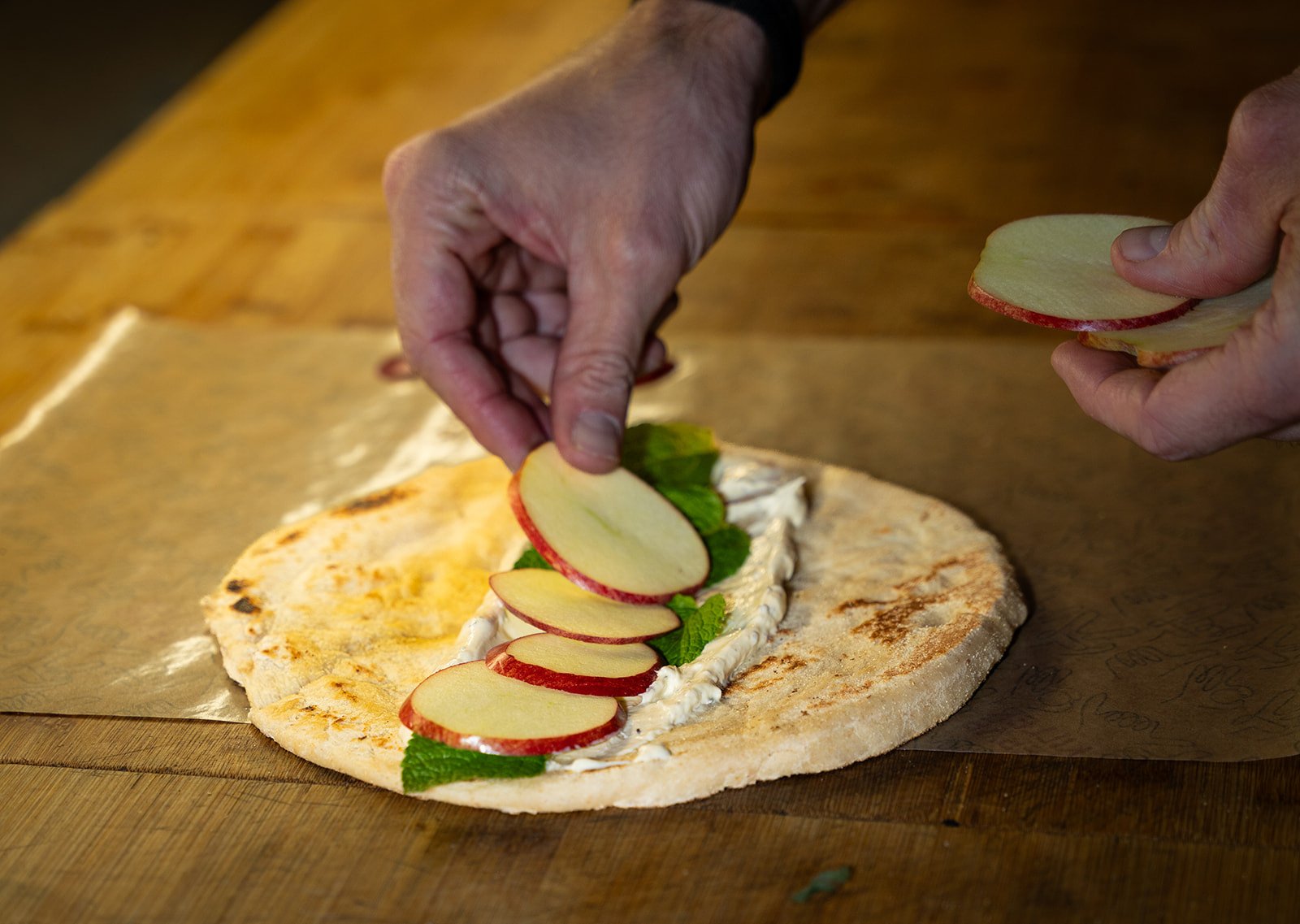 Fladbrød fyldes med salat og friske grøntsager på disken hos Killer Kebab