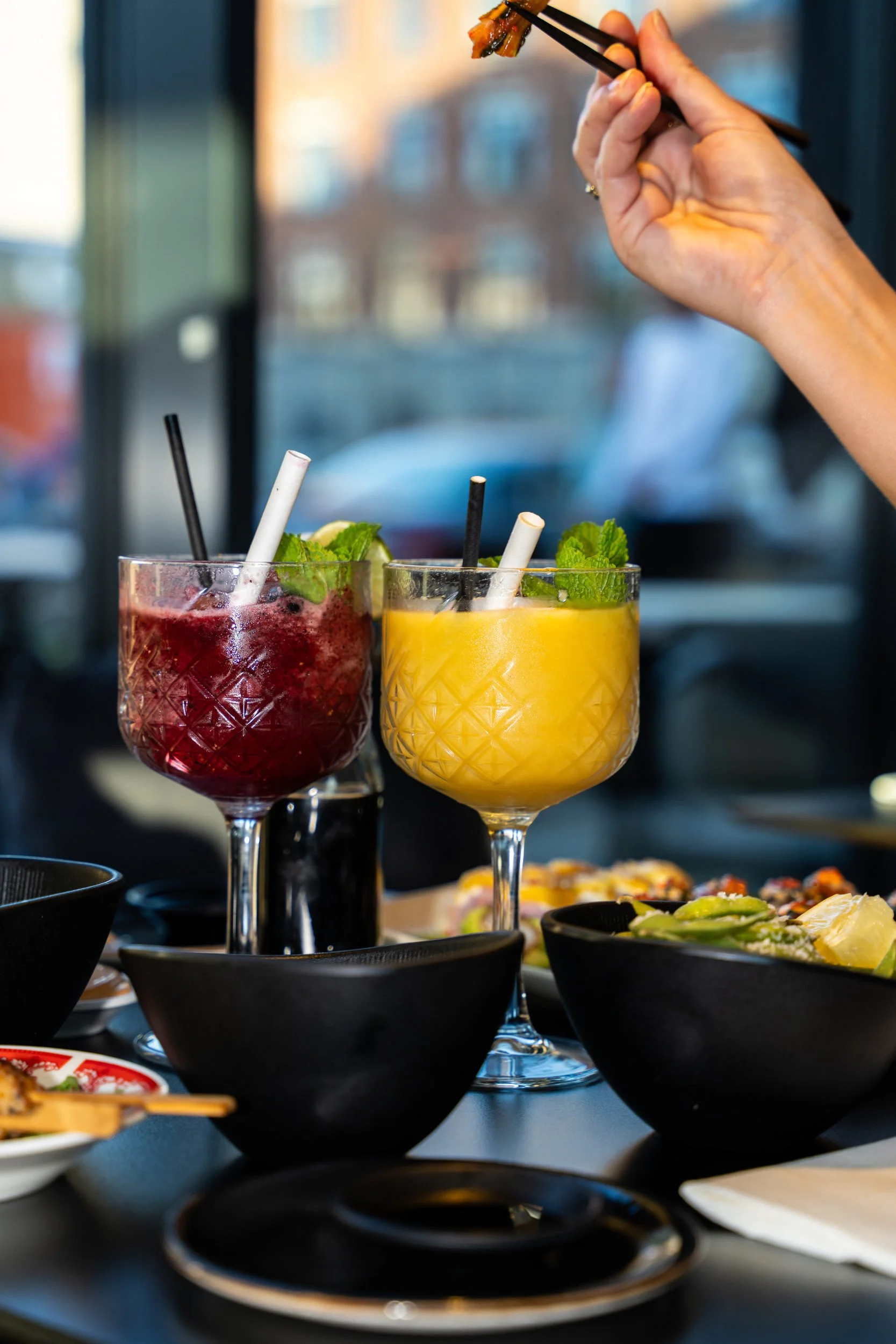 Rød og gul cocktail med pynt på bordet hos Sushi Lab København