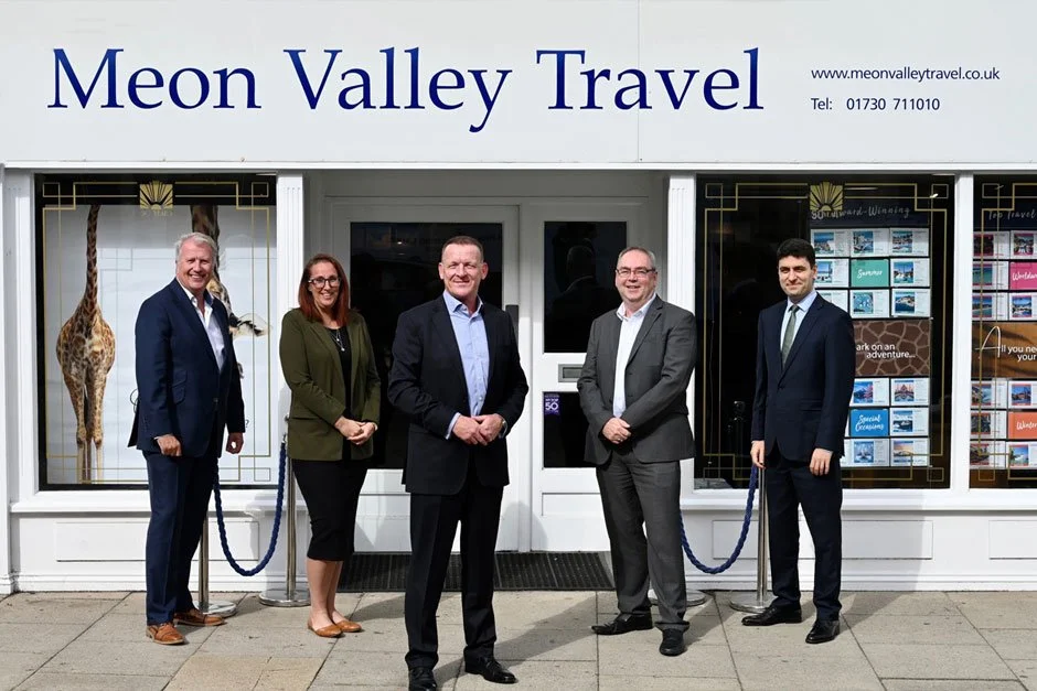 Meon Travel Directors in front of shop