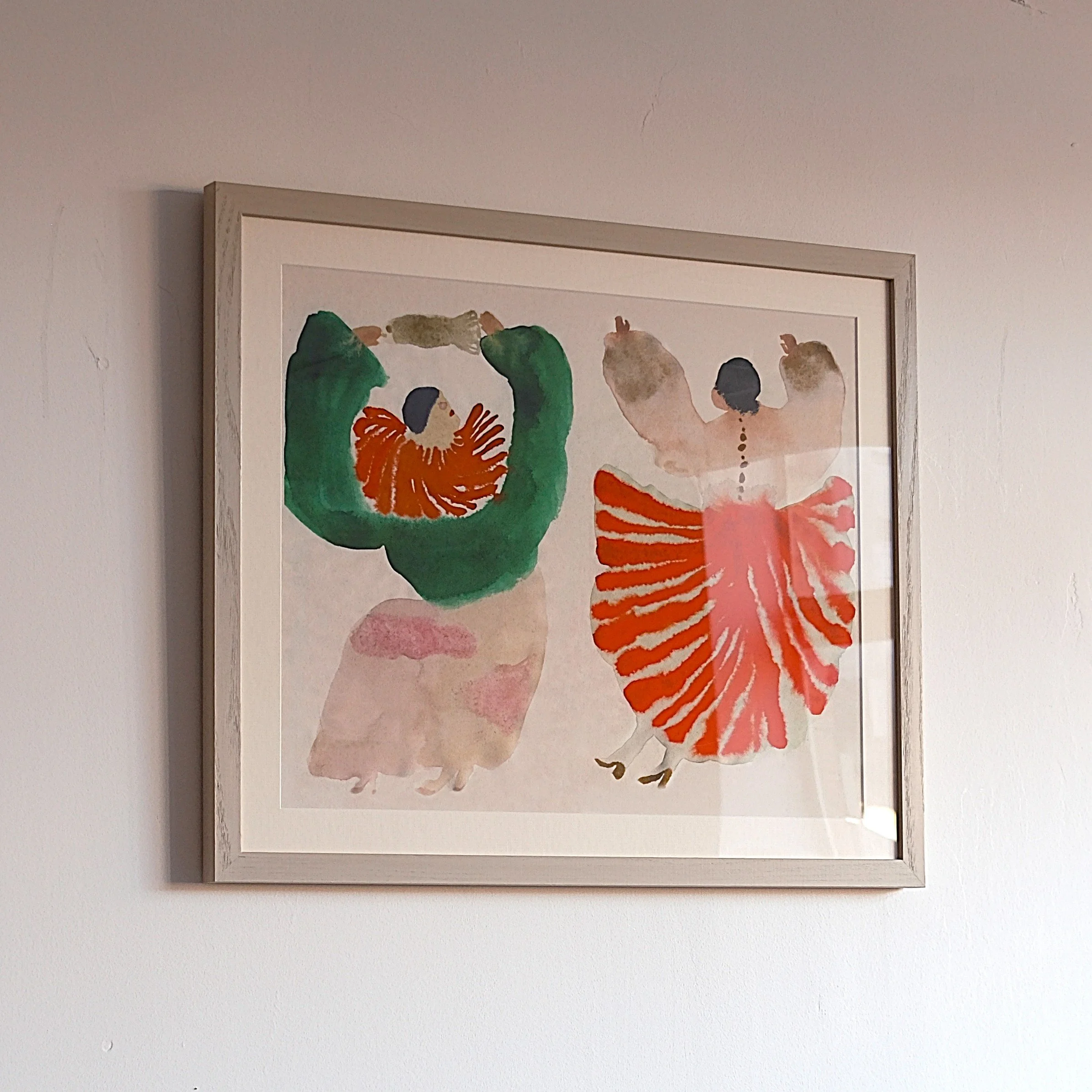 Watercolor painting of two dancers in traditional costumes, one with a green top and orange skirt, the other with a white top and red striped skirt, facing away with arms raised.