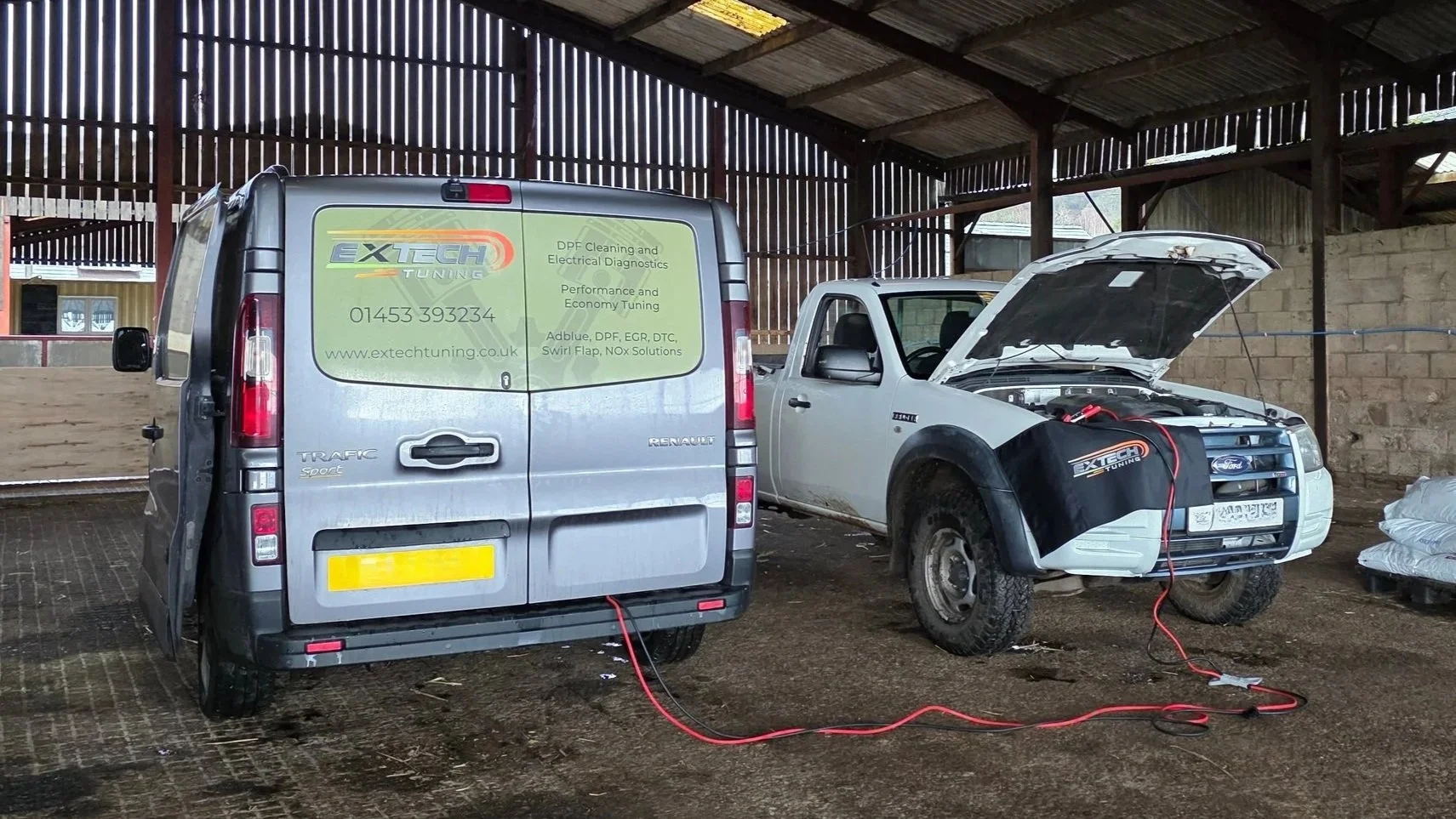 ExTech van working on a customer's car in a barn
