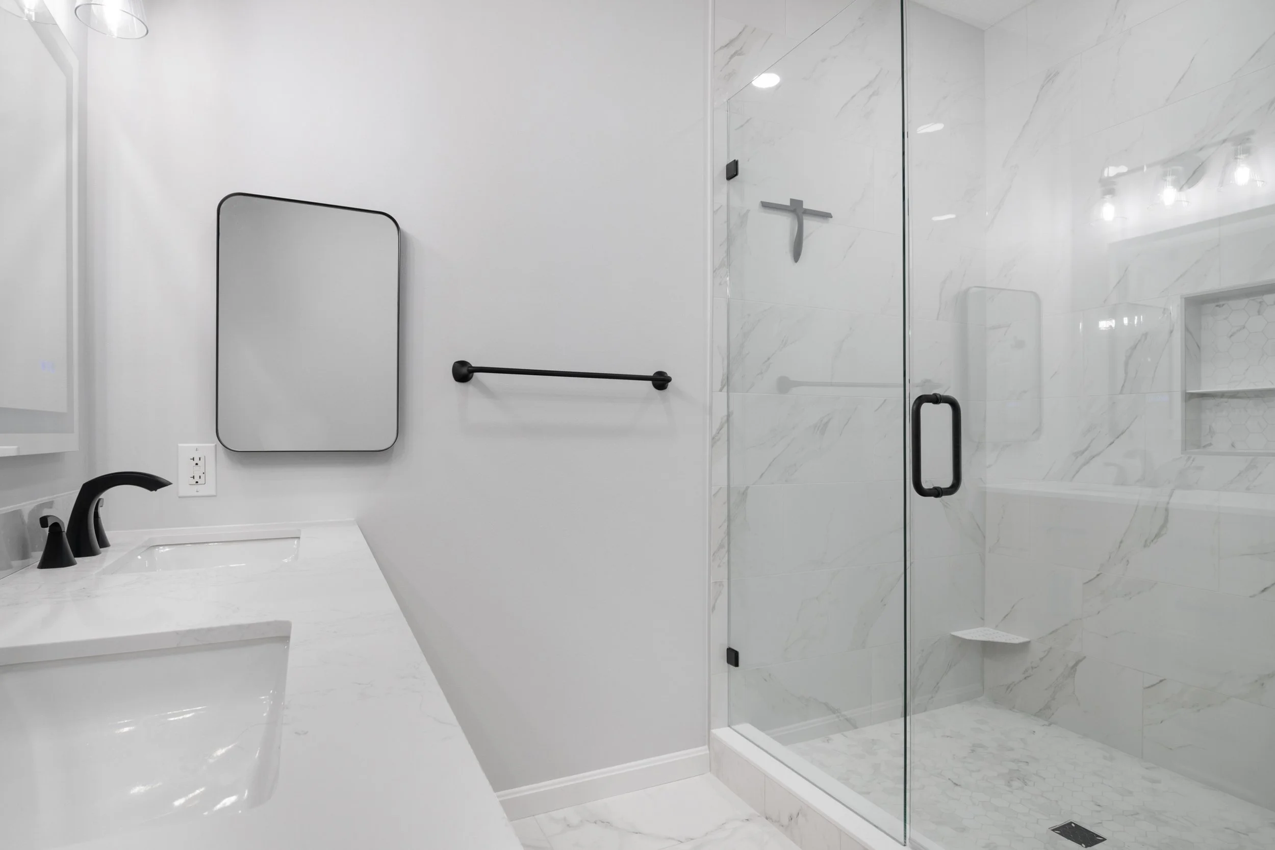 Bright remodeled primary bathroom in Christiansburg, Virginia with a spacious walk-in shower, double vanity and LED mirror