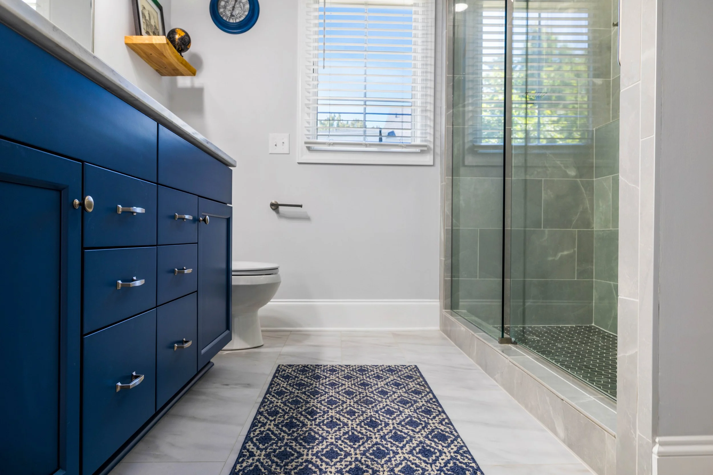 Frosted Pearl luxury vinyl tile flooring beside the blue bathroom vanity.