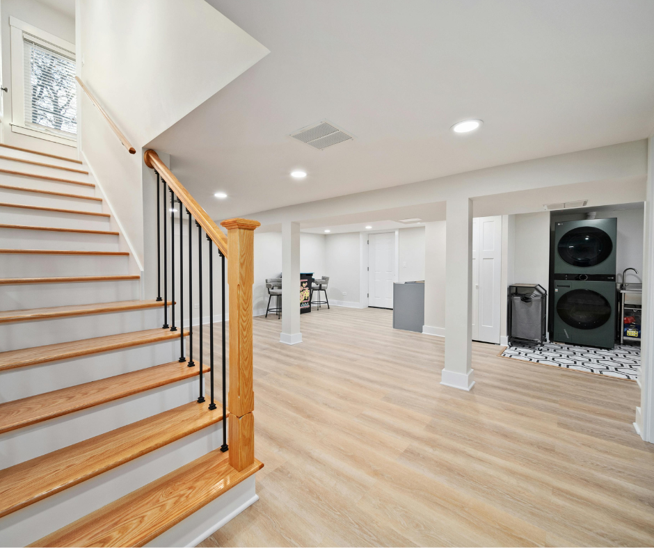 Bright open finished basement with columns and hardwood flooring